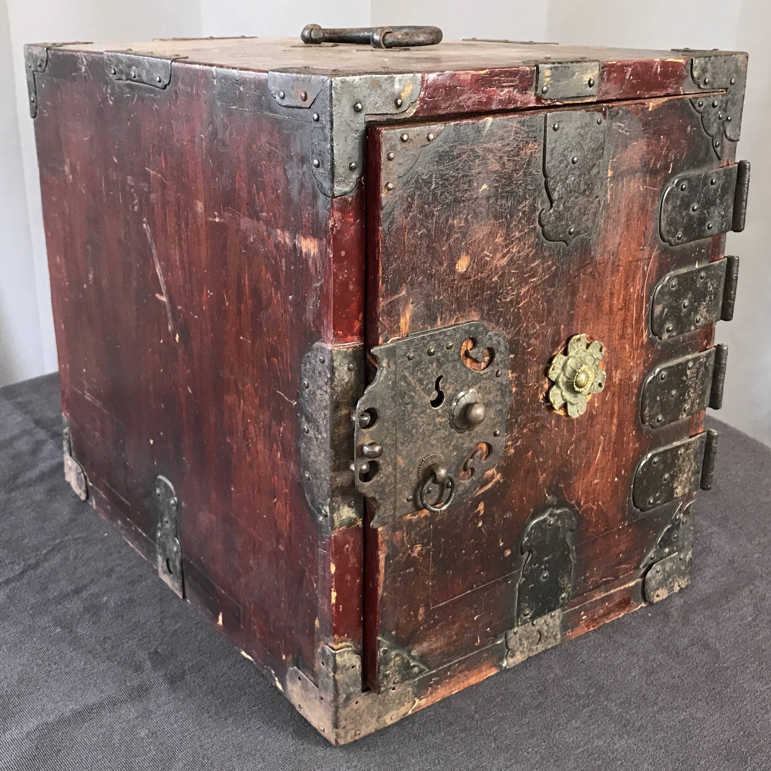 A compact and portable antique Chinese seaman’s or sailor’s chest with drawers, locks, and rare original key.

Handsomely worn wood with weathered reddish-brown finish displays intriguing history of chest being well-travelled and regularly relied