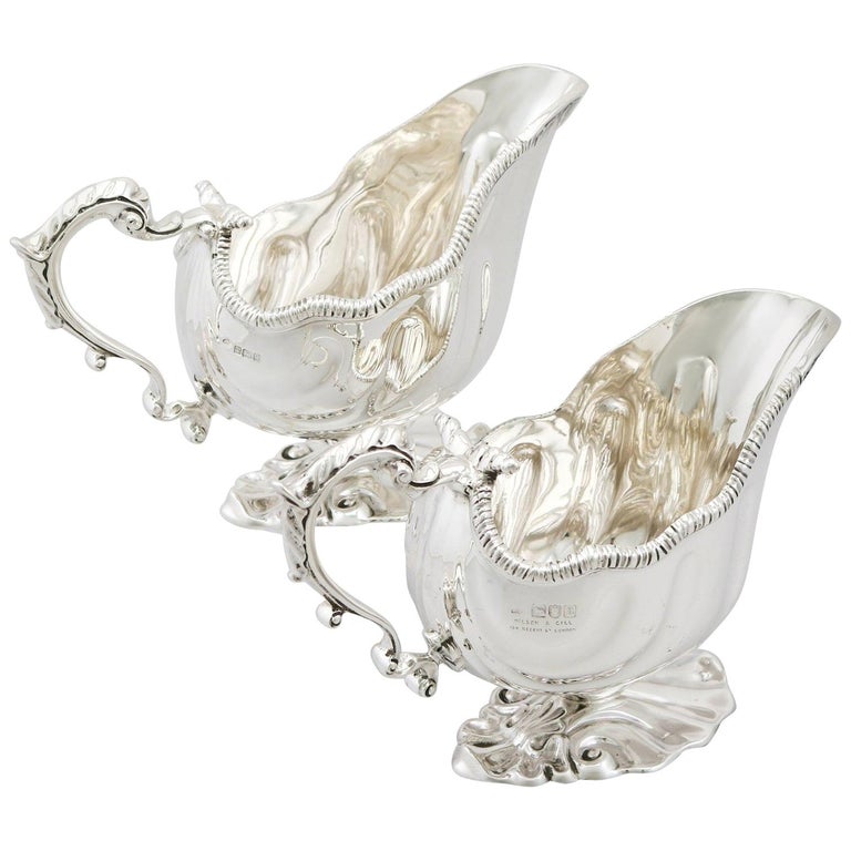 An exceptional, fine and impressive, composite pair of antique English sterling silver gravy boat made in the George II style; an addition to our dining silverware collection

These exceptional antique sterling silver gravy boats have an oval