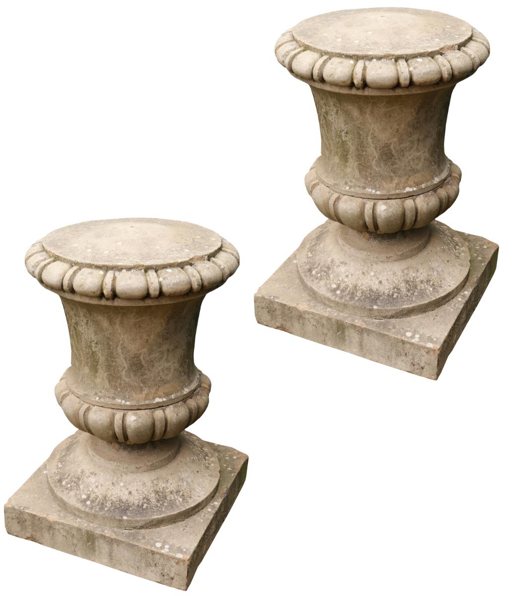 A pair of large scale lidded composition stone urn finials. Suitable for use as gate piers or as garden ornaments.