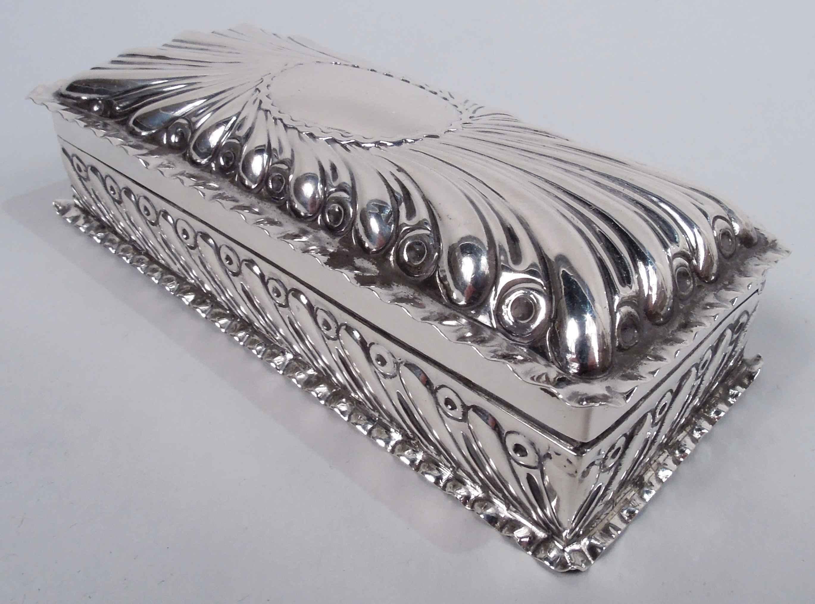 Victorian Classical sterling silver trinket box. Made by William Comyns in London in 1891. Rectangular with straight sides; cover hinged with curved top. Chased gadrooning. Cover top has central oval (vacant) with wavy border. Crimped cover and base