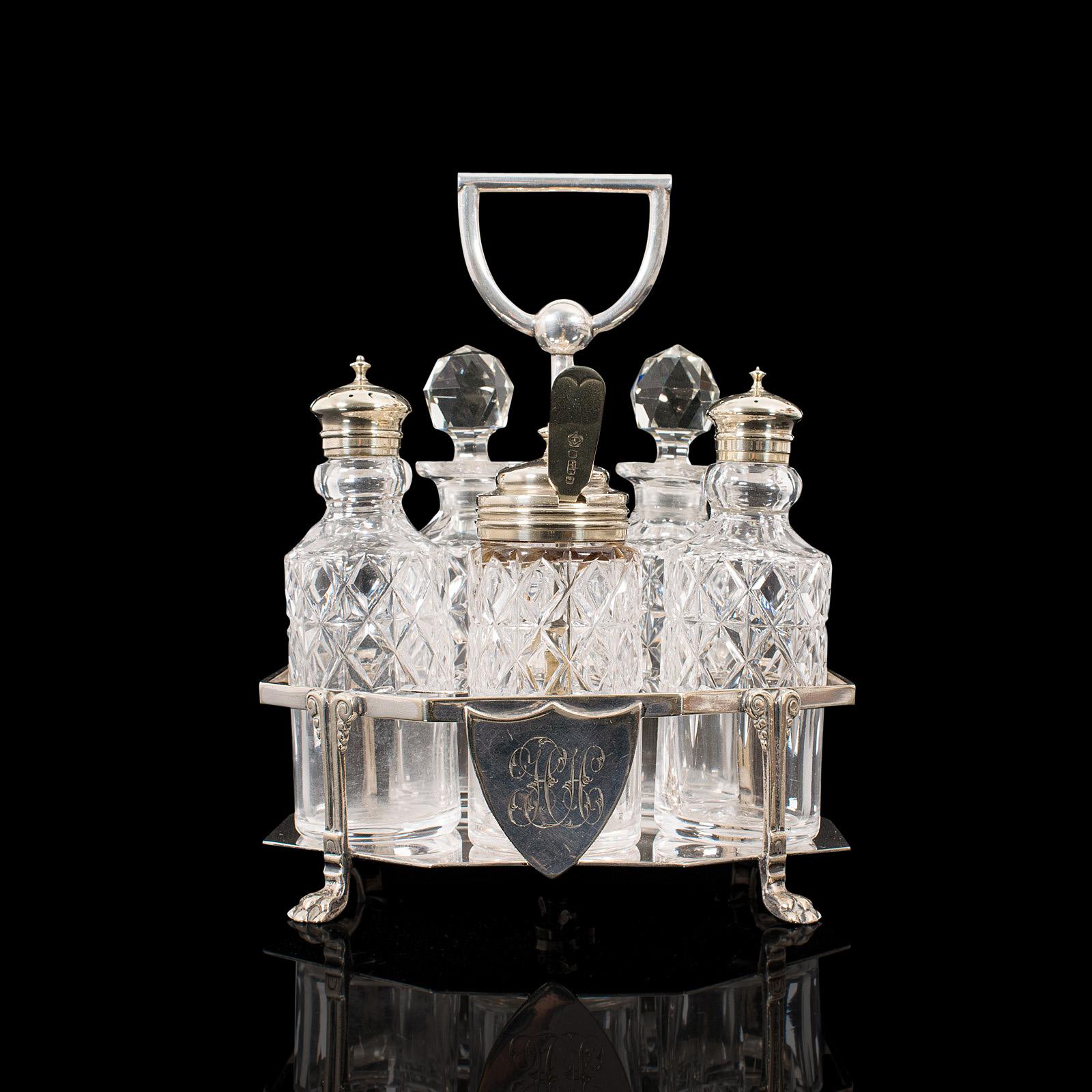 This is an antique condiment serving set. An English, silver plated table rack by Philip Ashbury and Sons of Sheffield, dating to the Edwardian period, circa 1910.

Attractive 5-piece condiments set for the dinner table
Displays a desirable aged