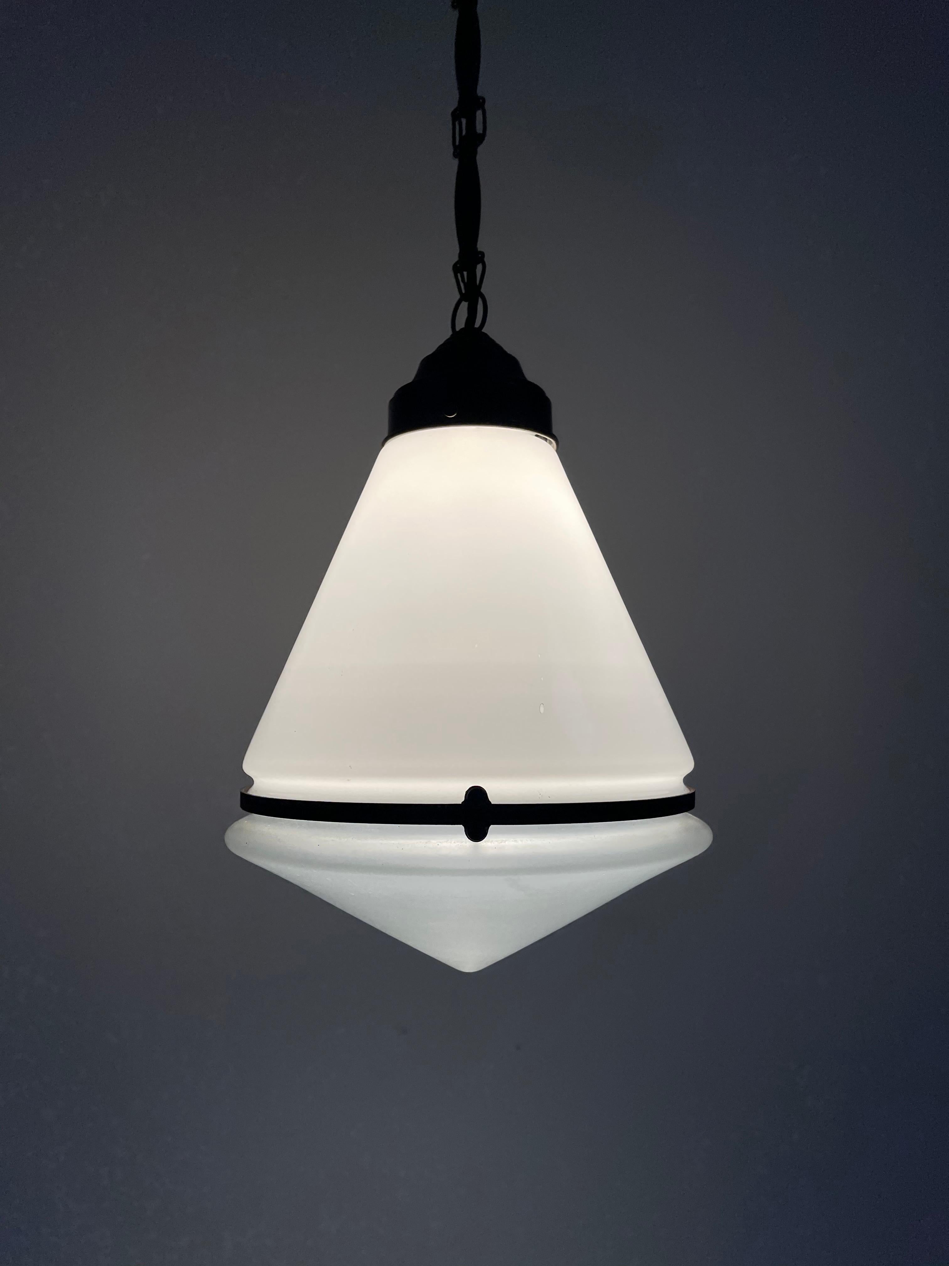- An original and incredibly rare conical pendant light by Peter Behrens for AEG, German circa 1920. 
- The light has two glass parts, the upper section is opaline and the lower triangular dish is frosted. 
- Fantastic original condition, a