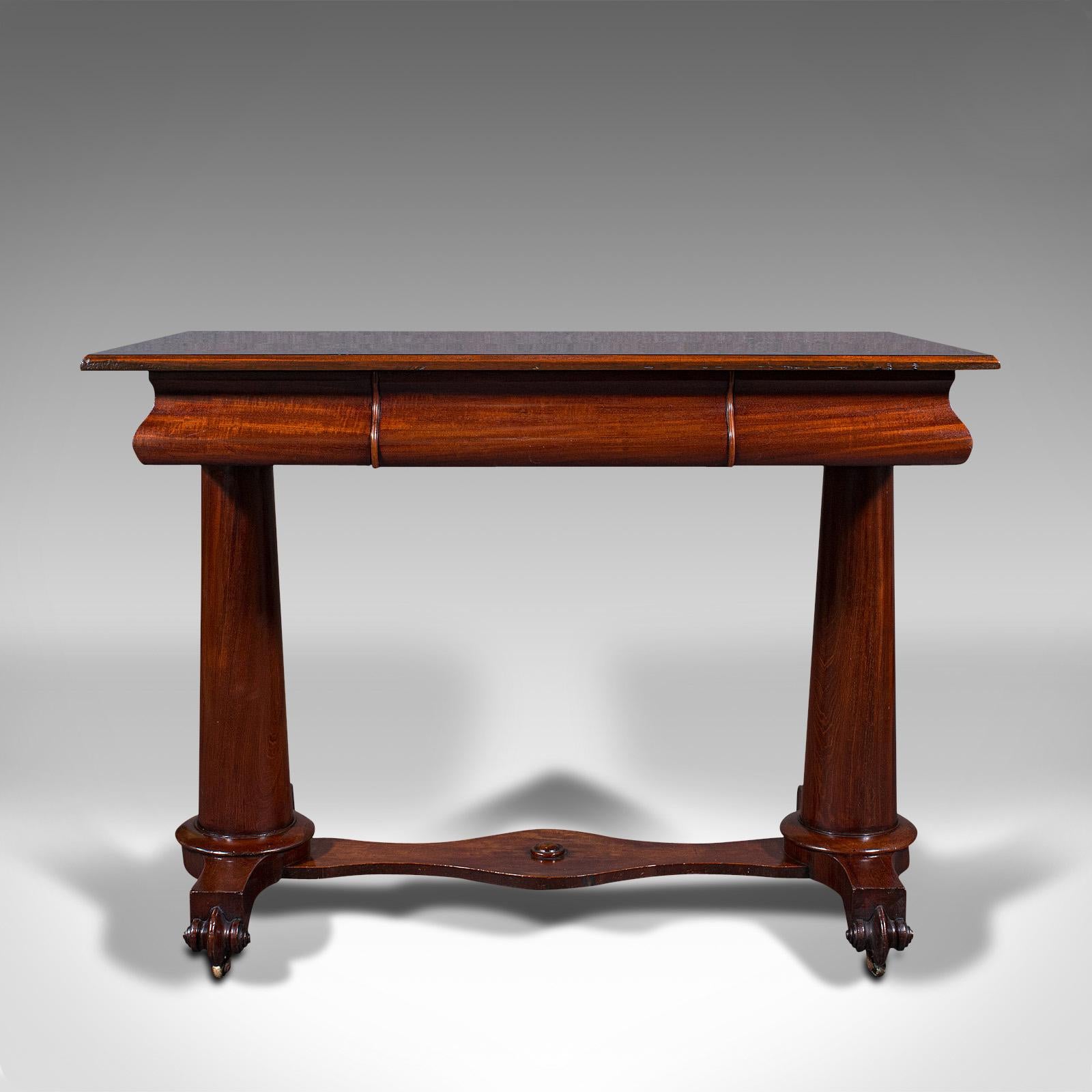 This is an antique console table. An English, rosewood and mahogany side or occasional table, dating to the Regency period, circa 1820.

Of superior, striking craftsmanship and finish
Displays a desirable aged patina throughout
Select stocks