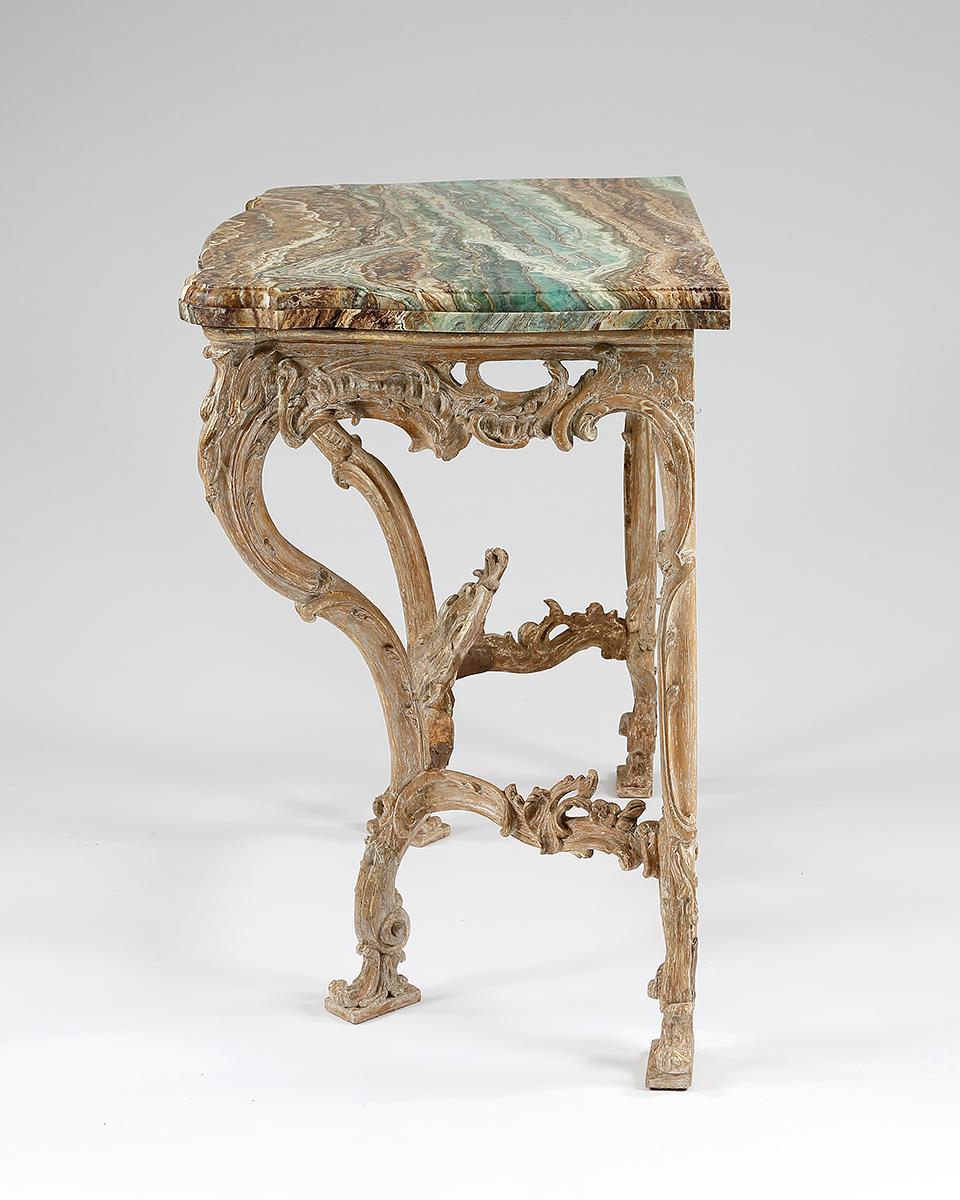 A fine quality serpentine fronted giltwood console table designed in the French manner. Beautifully carved in the Rococo manner with entwined C-scrolls. The marble top is possibly later, European,
circa 1760.