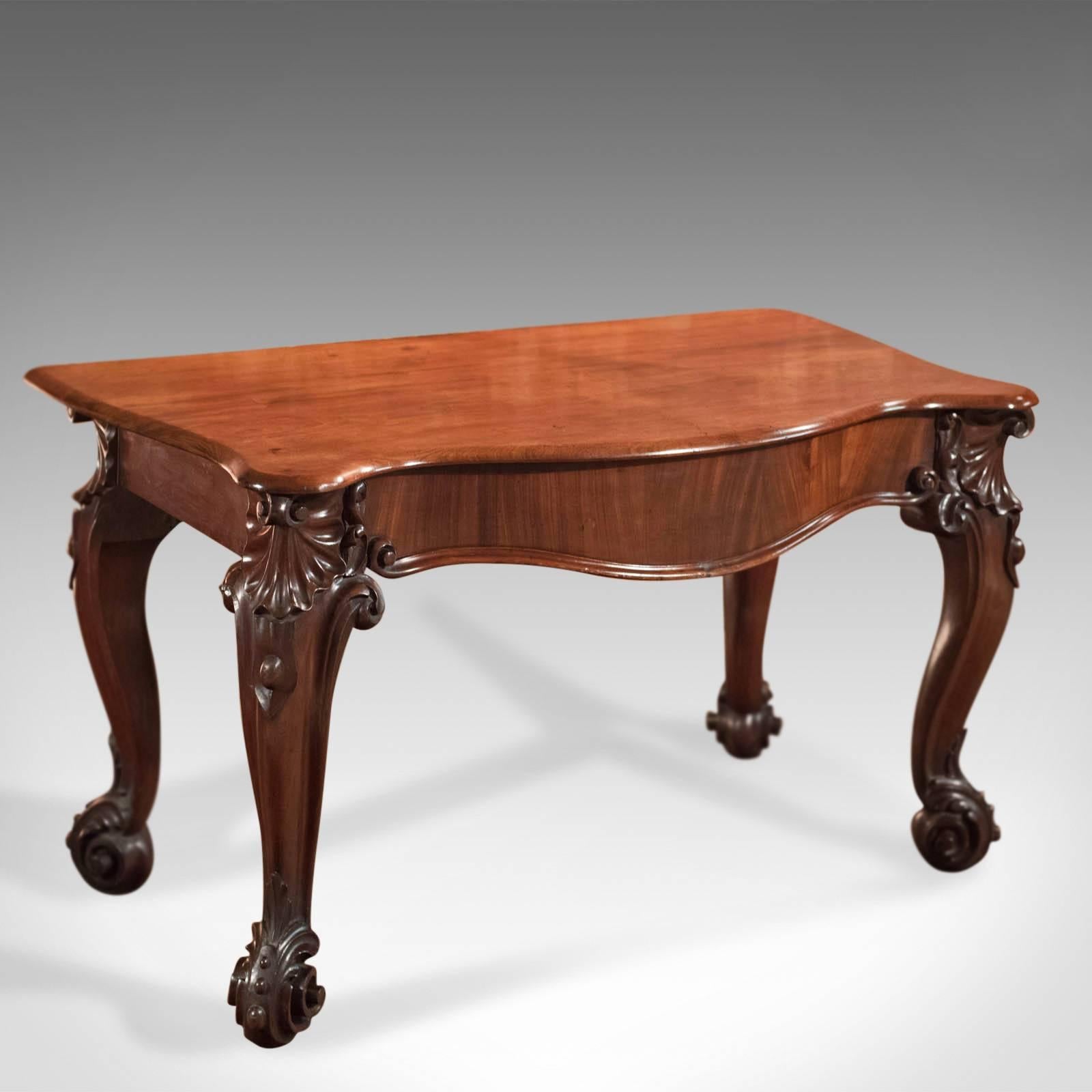 This is an antique console table, an English, Victorian mahogany serving table dating to the mid-Victorian period circa 1860.

Elaborate and attractive console or serving table 
Formerly a dining table displaying Victorian excess
First class