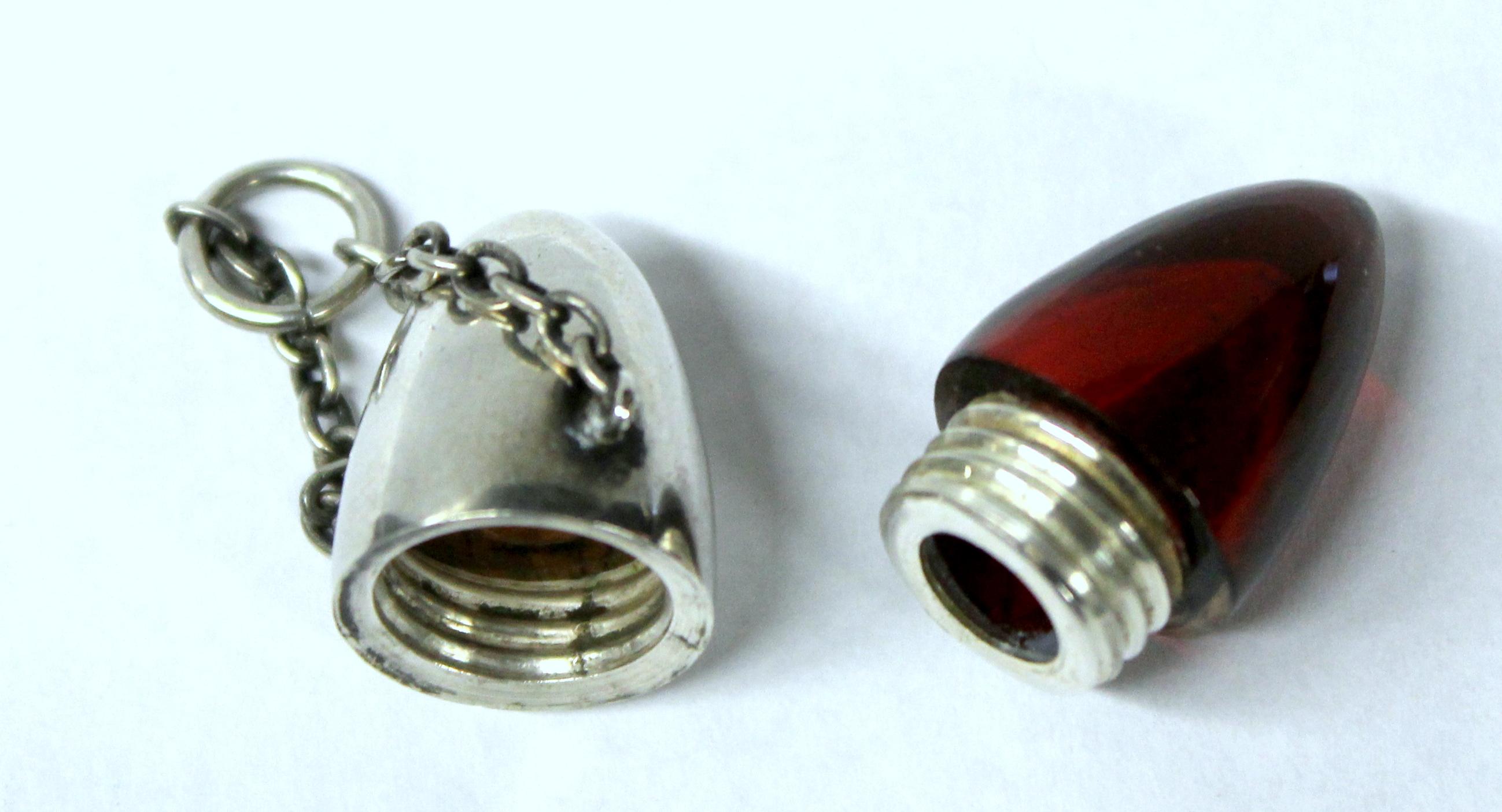 Very rare antique Continental .800 fine silver and ruby glass bullet-shaped vinaigrette or scent/perfume bottle

Tested .800 fine silver no hall marks found.
(For smelling salts or perfume)

Retains its rare, original chatelaine (chain) and