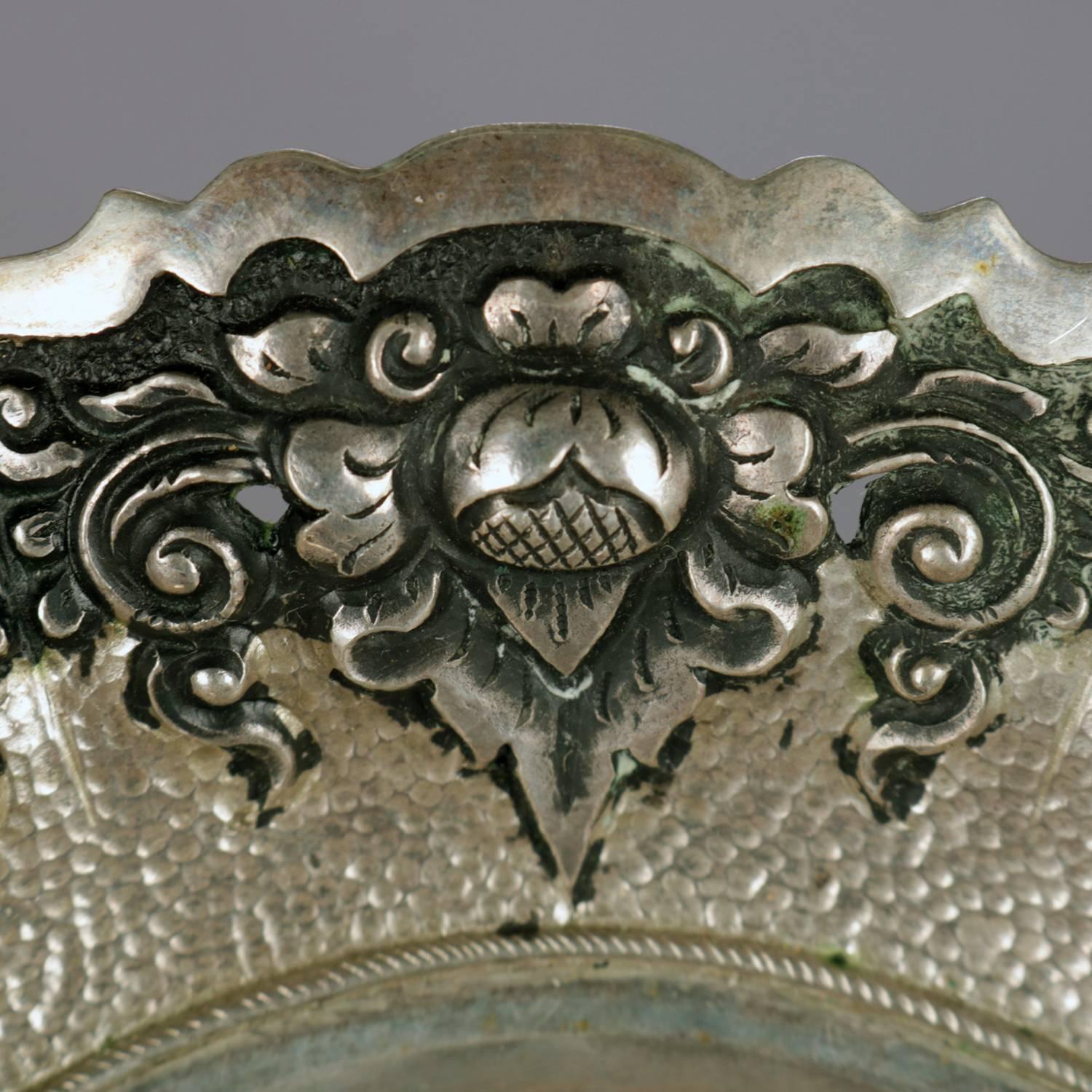 Continental .800 silver bride's basket features reticulated floral and scroll repousse border, swivel handle, en verso and handle marked .800, 5.49 toz, circa 1890

Measures: up 5