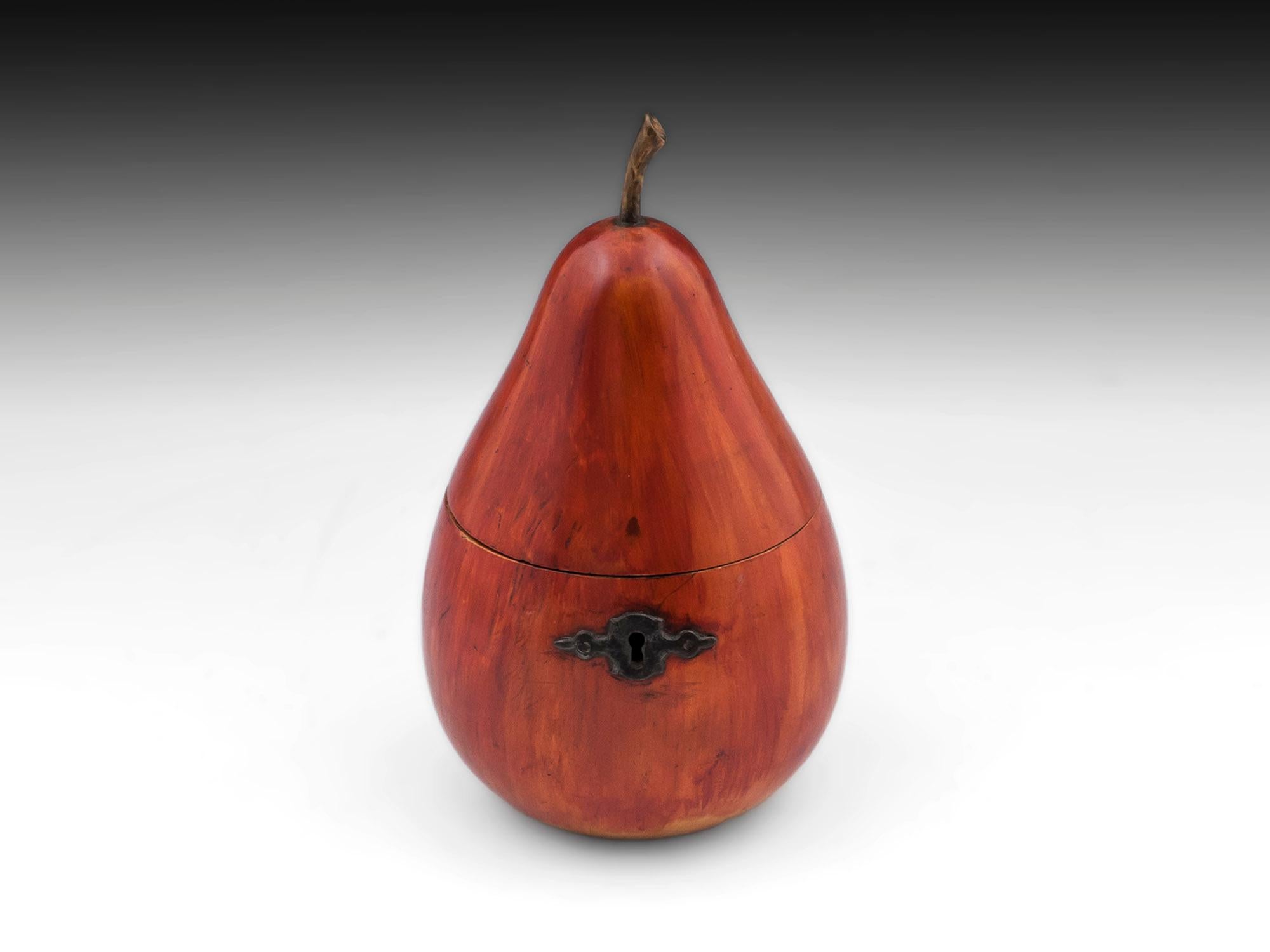Beautiful shaped pear tea caddy with wonderful vibrant red blushing to its body having a realistic wooden stalk, with steel hinge, lock and ornate escutcheon. 

The antique pear tea caddy still has traces of tin lining and has a working lock with
