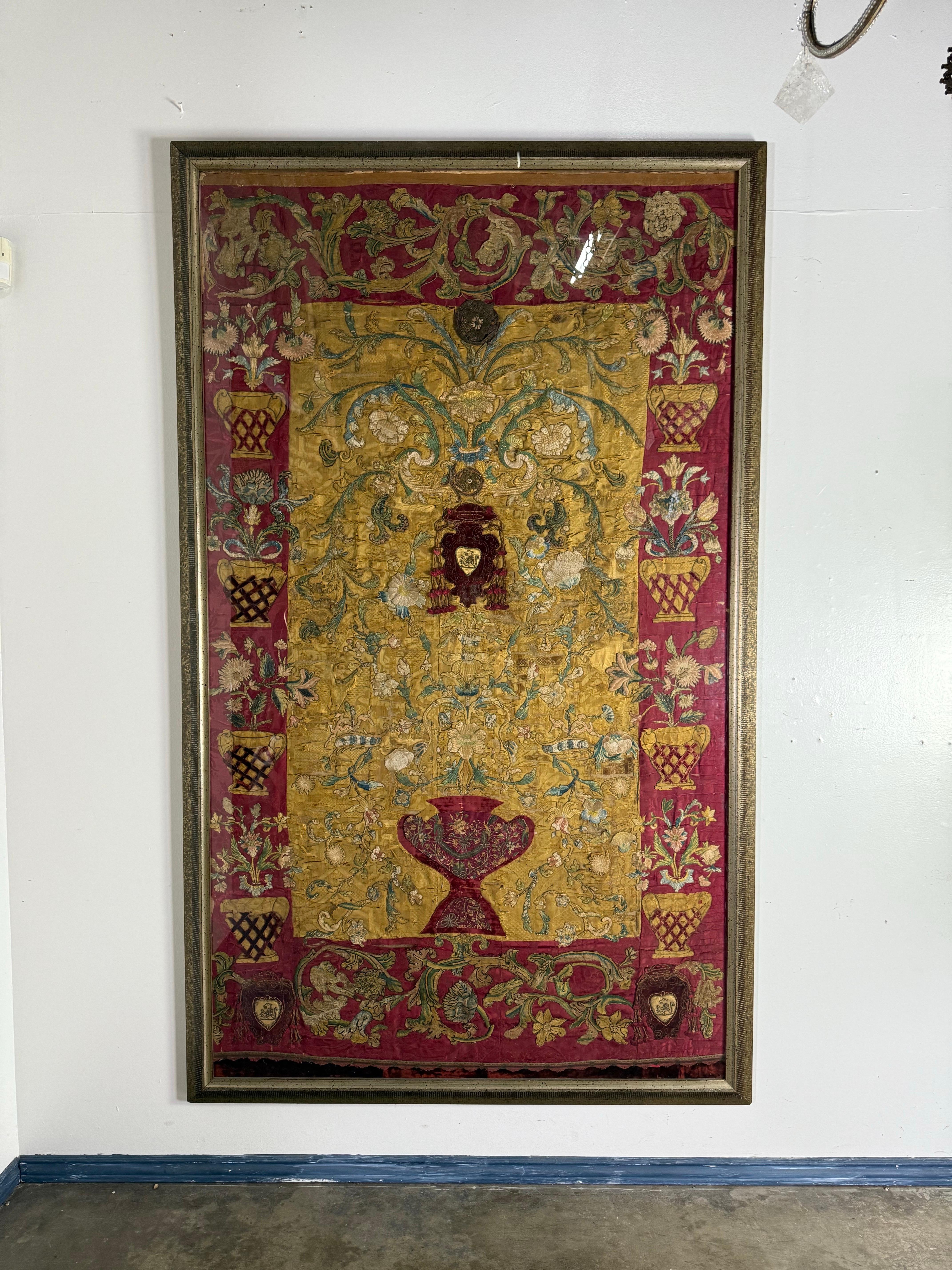A richly detailed framed ecclesiastical textile panel, Continental European, late 17th to early 18th century. Originally part of a church vestment or altar frontal, the piece is worked in couched gilt and silver metallic threads with silk embroidery