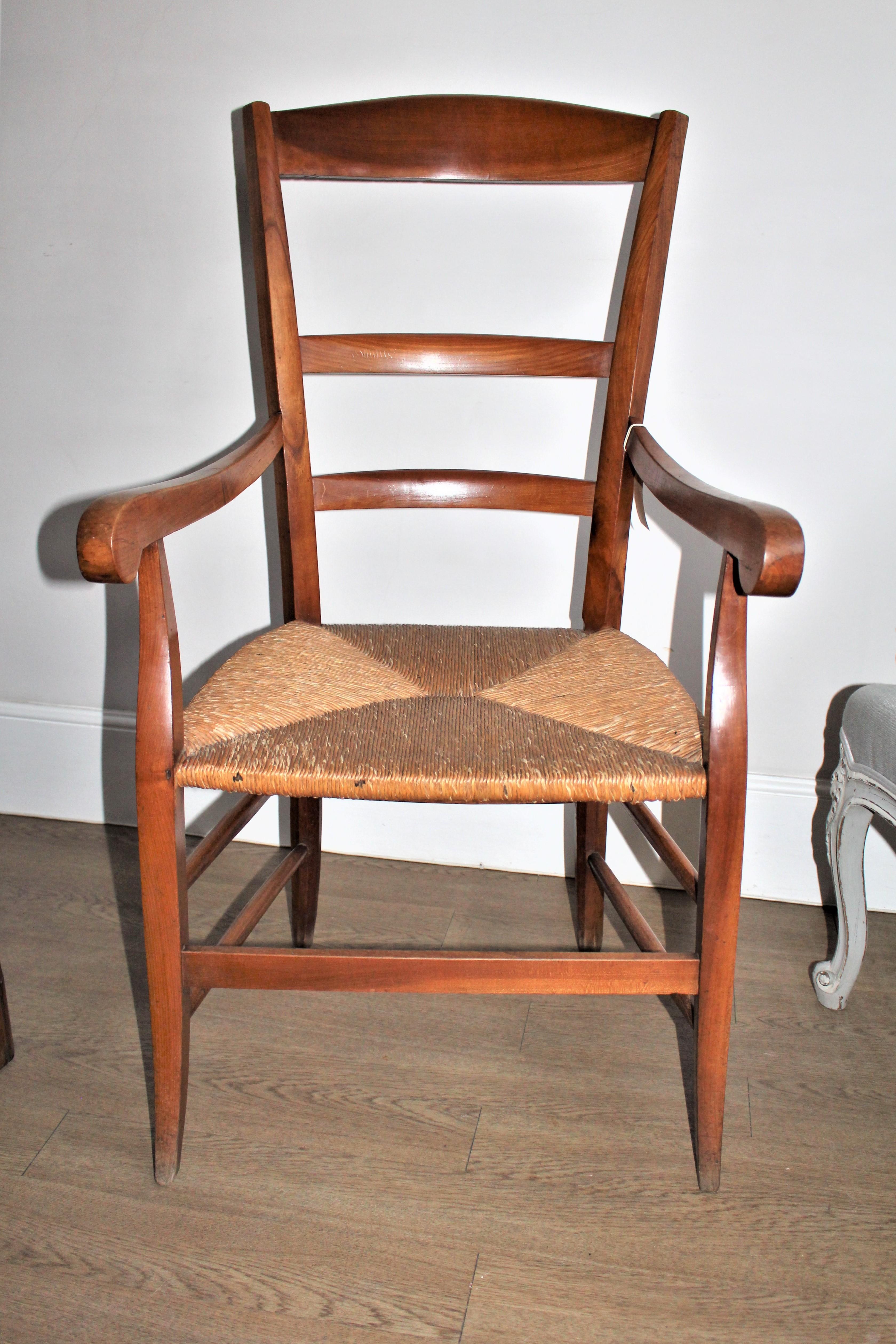 Early 1900s country French provincial cherrywood armchair with rush seat.
The rush seat being in very good condition makes it a comfortable chair.
This chair will look good in most rooms, either as a reading chair, by the fireplace, or simply to