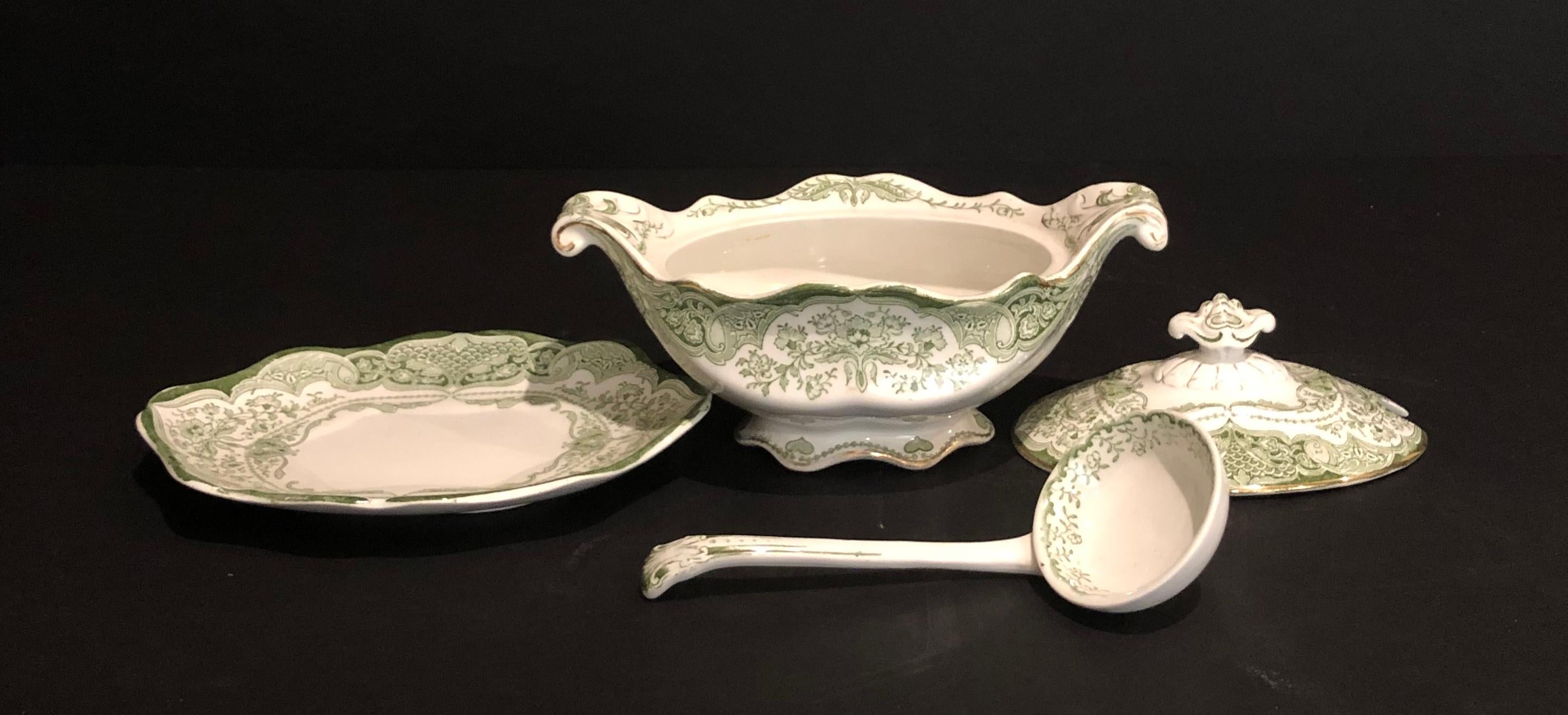 19th century antique ceramic continental green and white 4-piece gravy boat. Includes sauce boat, sauce ladle and under dish.
 
