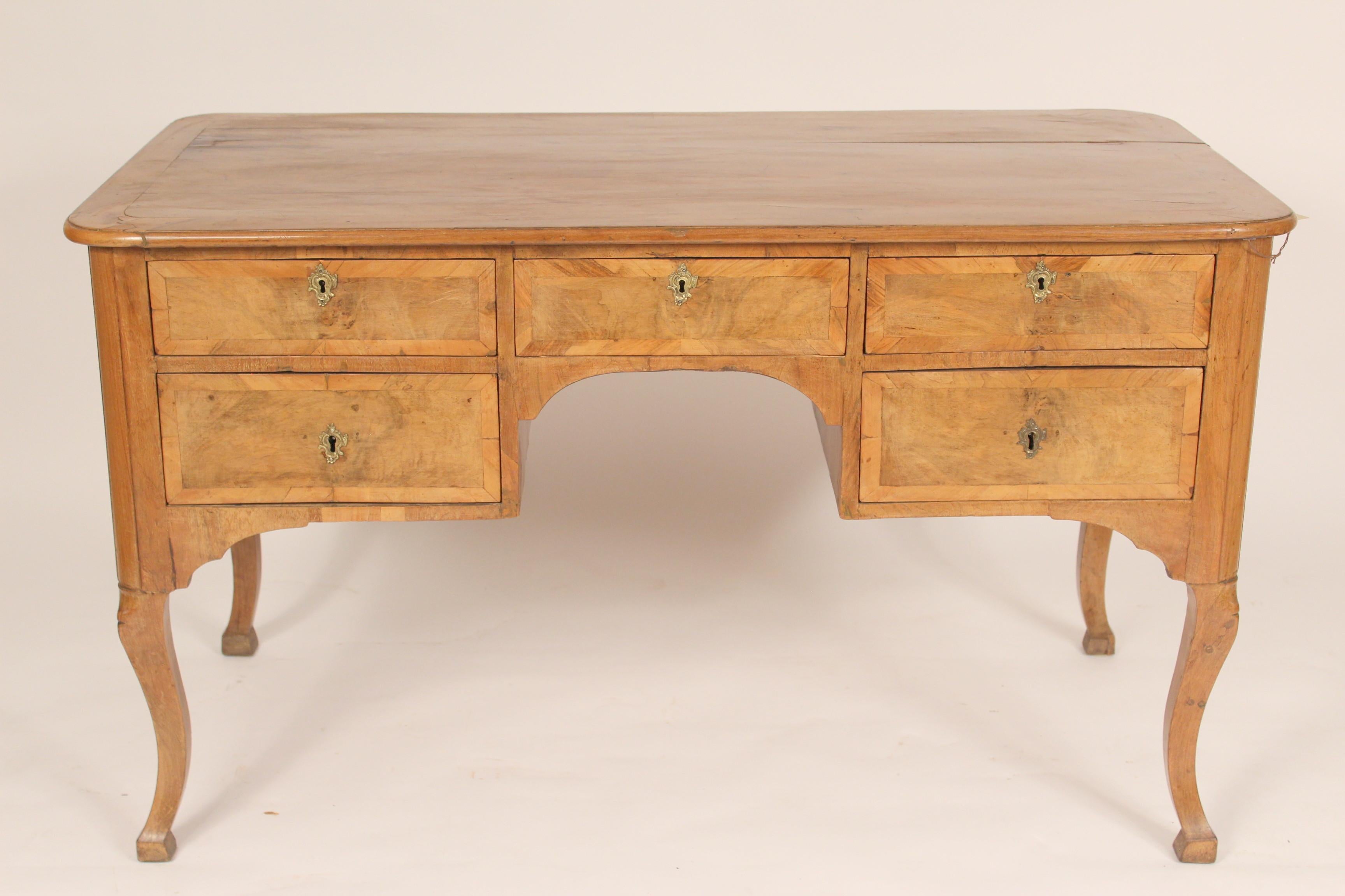 Antique continental Louis XV style walnut and beech wood desk, late 19th century. Nice color. Hand dove tailed drawer construction. Height of center of knee hole to floor 24