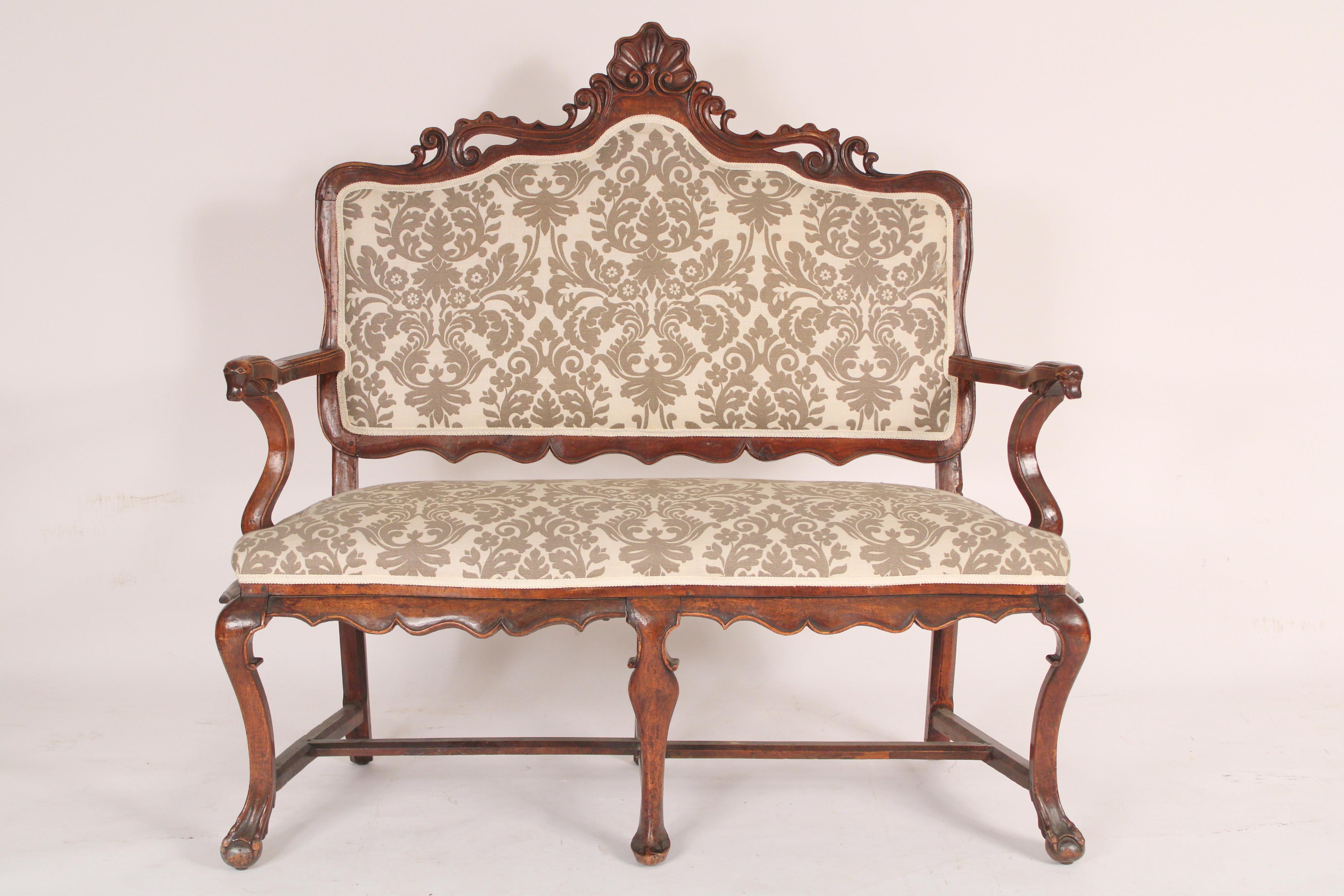 Continental Louis XV style walnut settee, 19th century. Walnut retains excellent old patina. Mortise tenon and peg construction. Recently reupholstered, upholstery in very good condition.