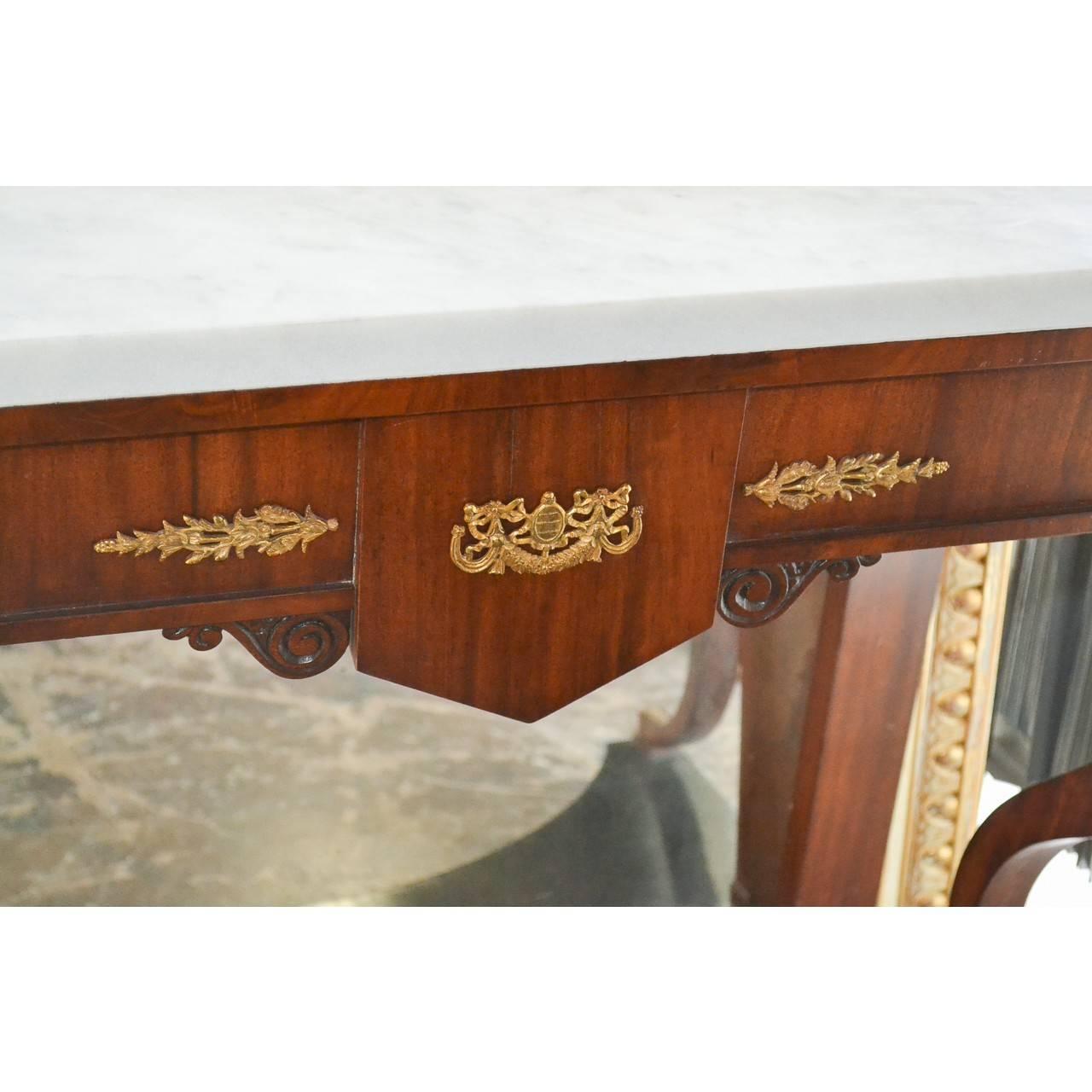 Superbly crafted circa 1900 Continental console table with a fine white Carrara marble top above a shaped frieze with superbly detailed bronze appliques and raised on curved legs and ebonized lower tier.

 