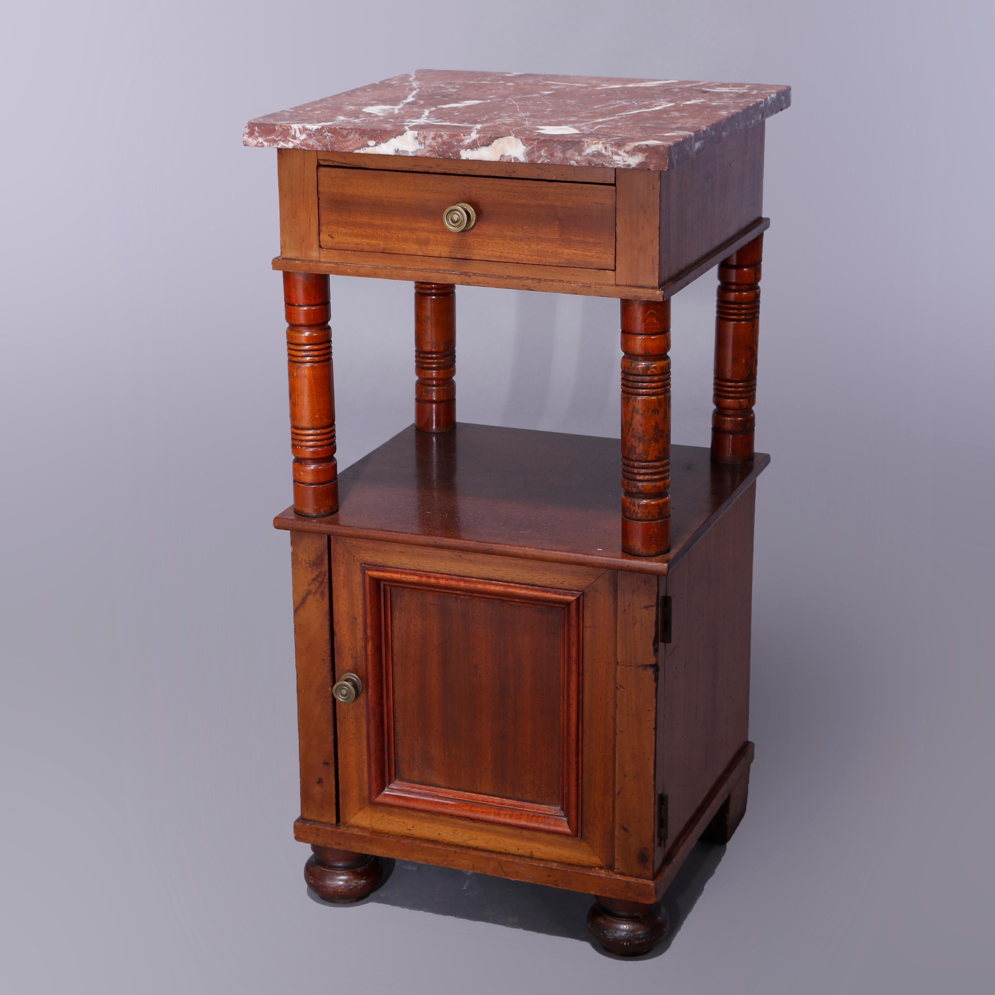 An antique Continental side stand offers marble top over mahogany frame having single drawer over lower shelf having turned supports and surmounting lower single drawer cabinet raised on bun feet, c1900

Measures - 30.75'' H x 15.75'' W x 15.75''