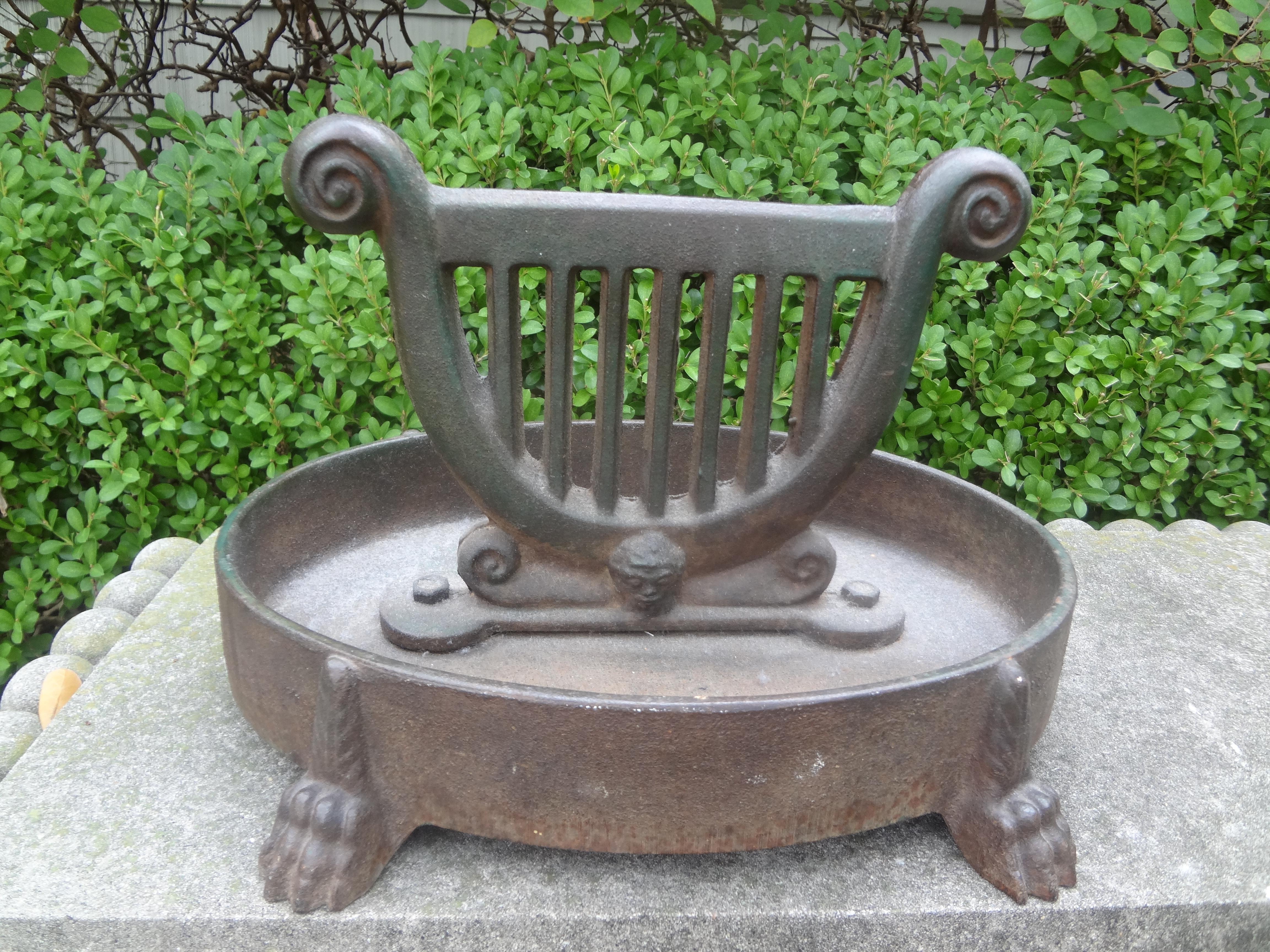 Vintage Continental Neoclassical Style Iron Boot Scraper.
This interesting Neoclassical style cast iron garden boot scraper has a beautiful lyre design a mask and paw feet. Great garden, mud room or bookcase accessory.