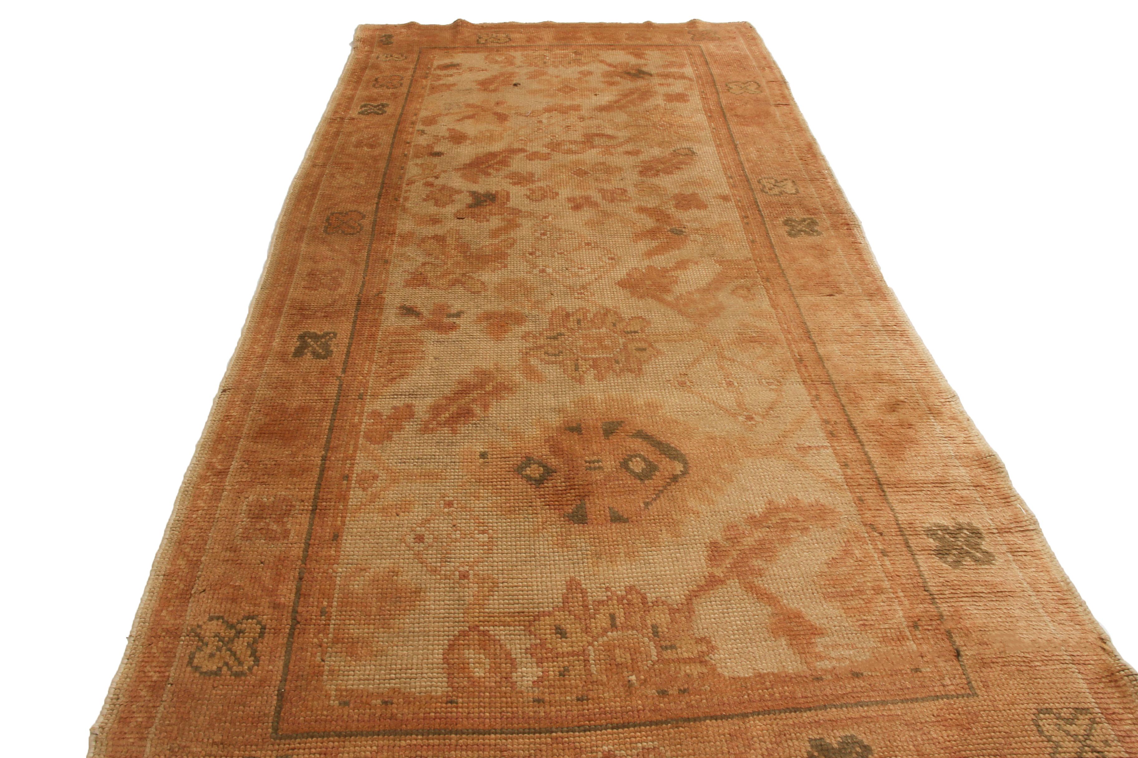 Originating from Ireland in 1890, this antique runner features a distinct Continental design, denoting a varied, traveled array of influences from various tribal regions of the 19th century. Hand-knotted in high-quality wool, the salmon-pink floral
