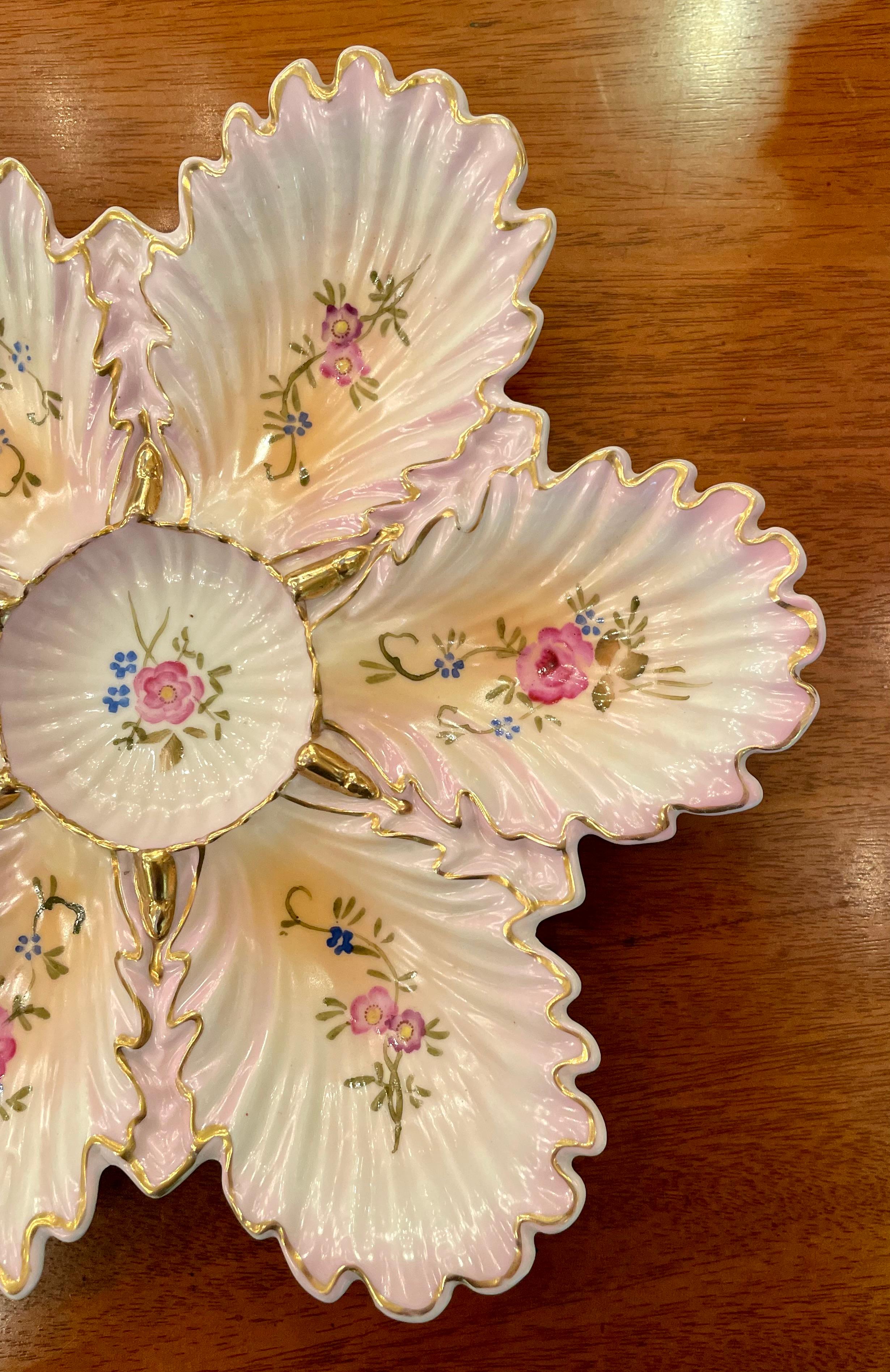 Antique Continental Pink & gold porcelain shaped oyster plate with Ruffled Edges, Circa 1880's.
Pretty hand-painting detail of pink florals and trailing vines.