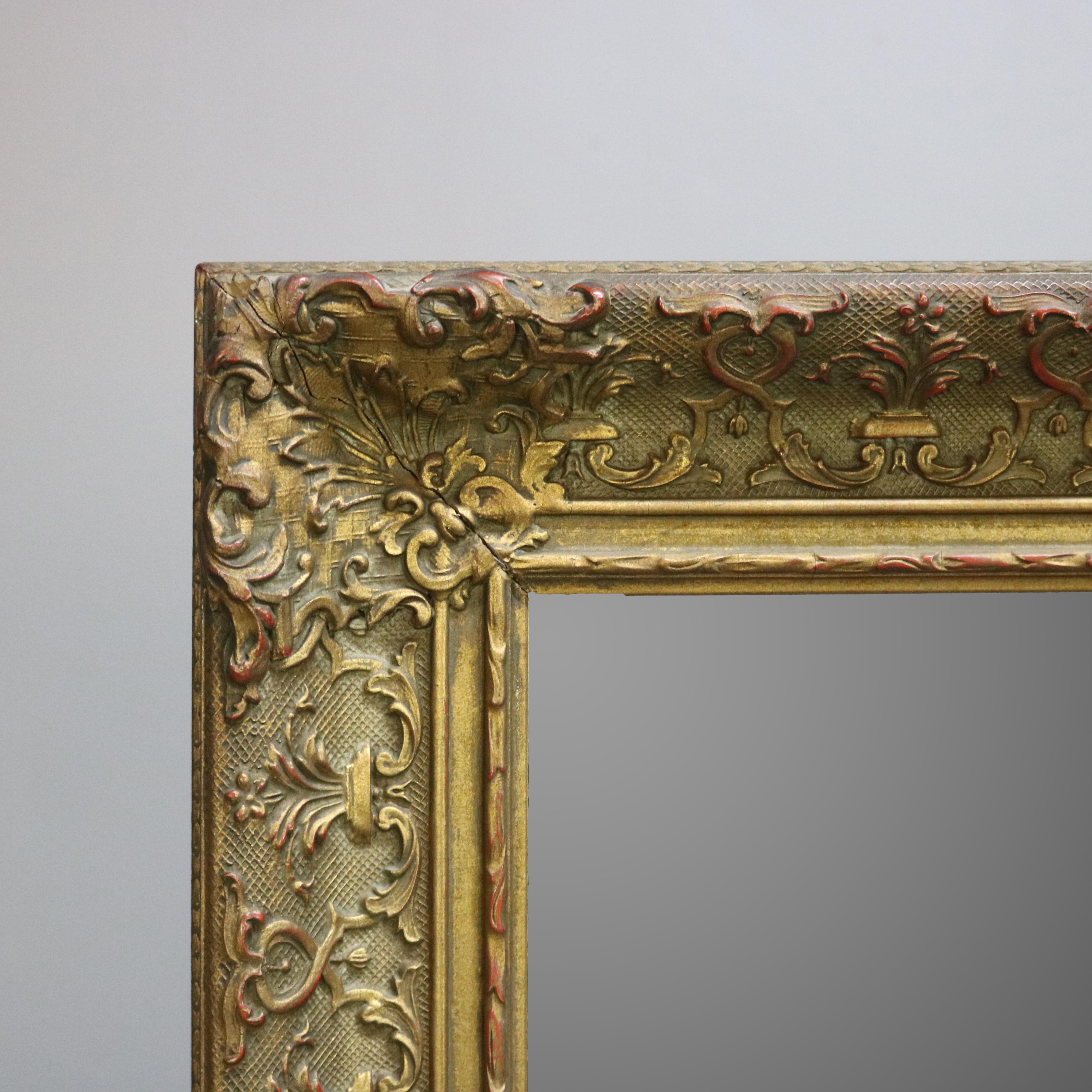 An antique and large Continental giltwood wall mirror offers frame with scroll foliate and stylized fleur-de-lis decoration, circa 1900

Measures - 30