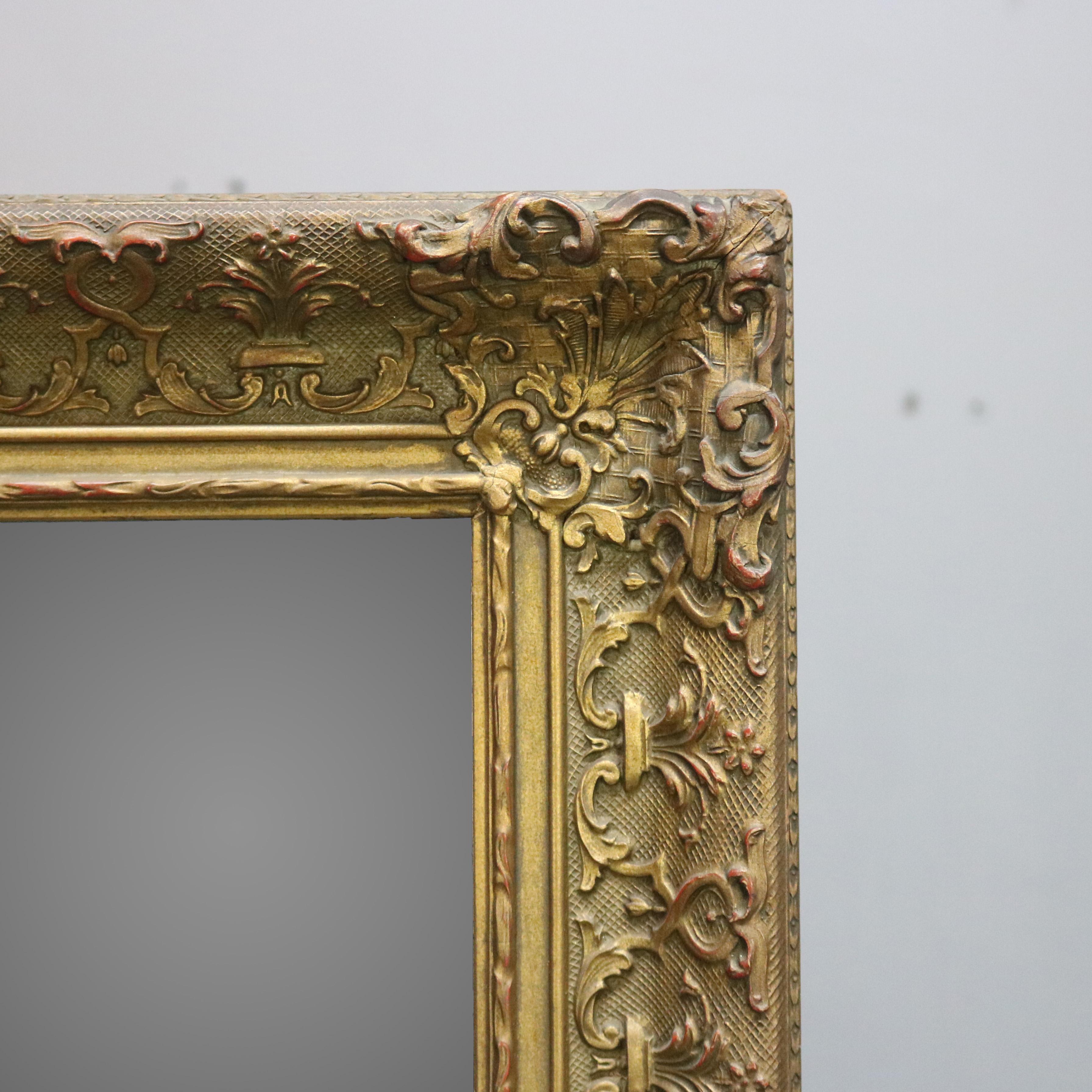 European Antique Continental Scroll and Foliate Giltwood Framed Wall Mirror, circa 1900 For Sale