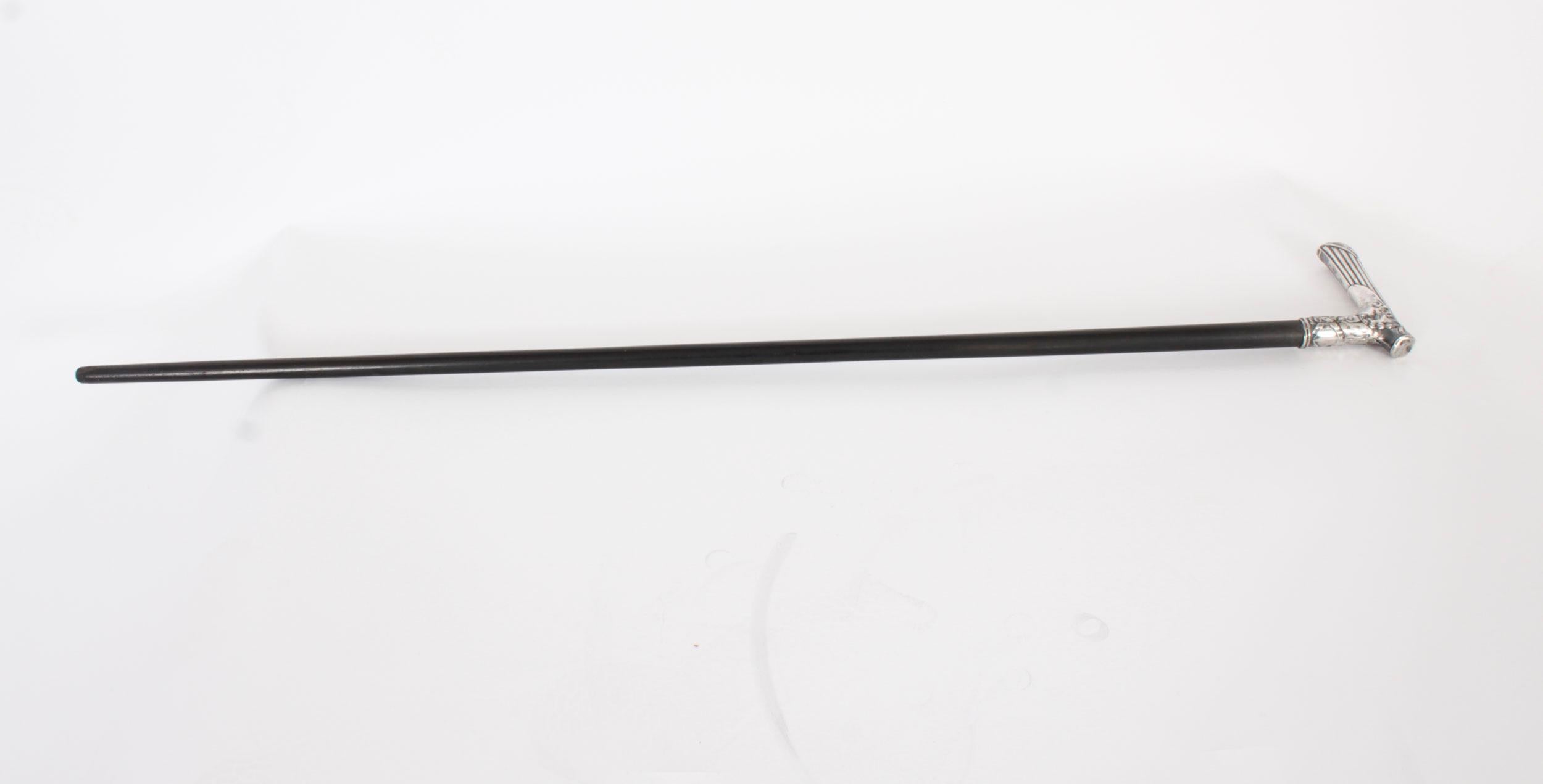 This is a beautiful antique continental silver pommel walking stick hall marked with a crown, and 360 FS, late 19th Century in date.
 
The striking stick features an ornate silver crutch handle featuring profusely embossed ribbons, on a gentle