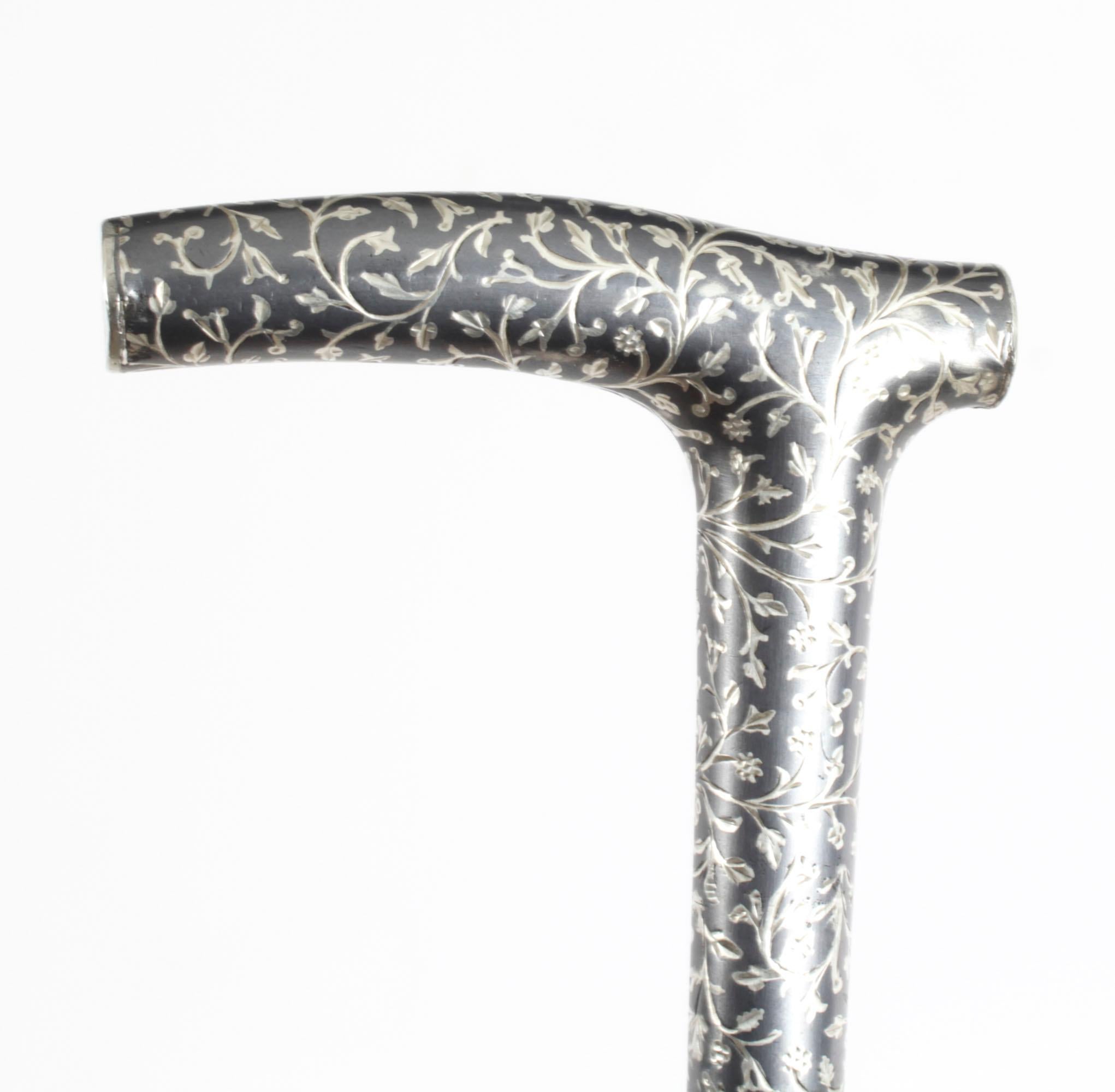 This is a beautiful antique continental silver niello decortated walking stick, circa 1880 in date
 
The striking stick features an ornate silver Crutch handle featuring profusely engraved floral Niello ornamentation on a gentle tapering  malacca