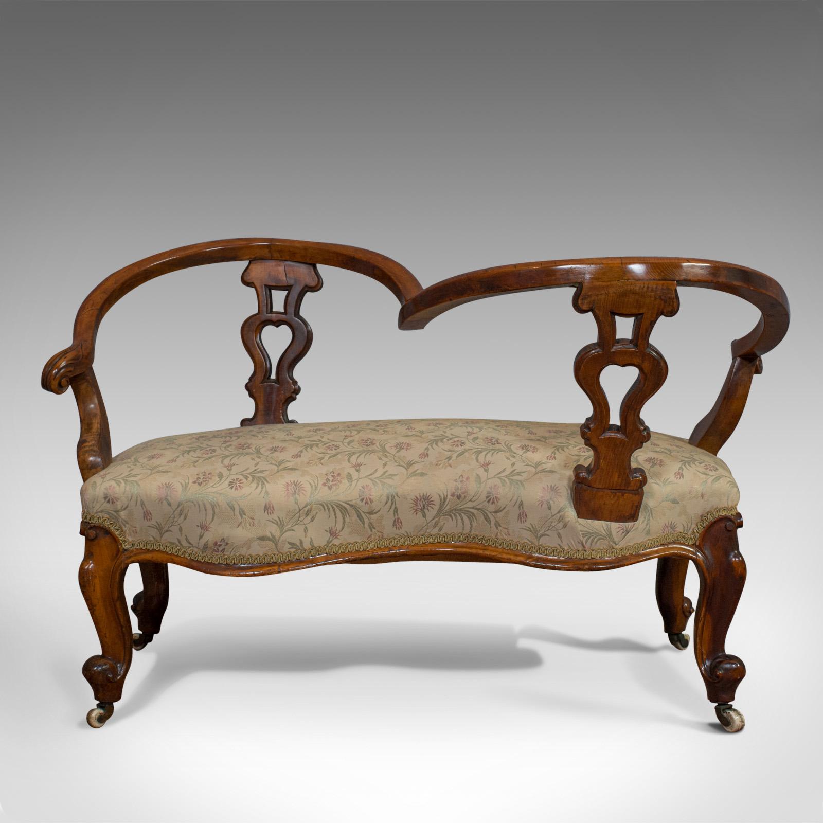 This is an antique conversation sofa. A English, fruitwood loveseat, tête-à-tête or courting bench, dating to the early Victorian period, circa 1840.

Sinuous, lustrous and perfect for the loquacious
Displays a desirable aged patina
Serpentine