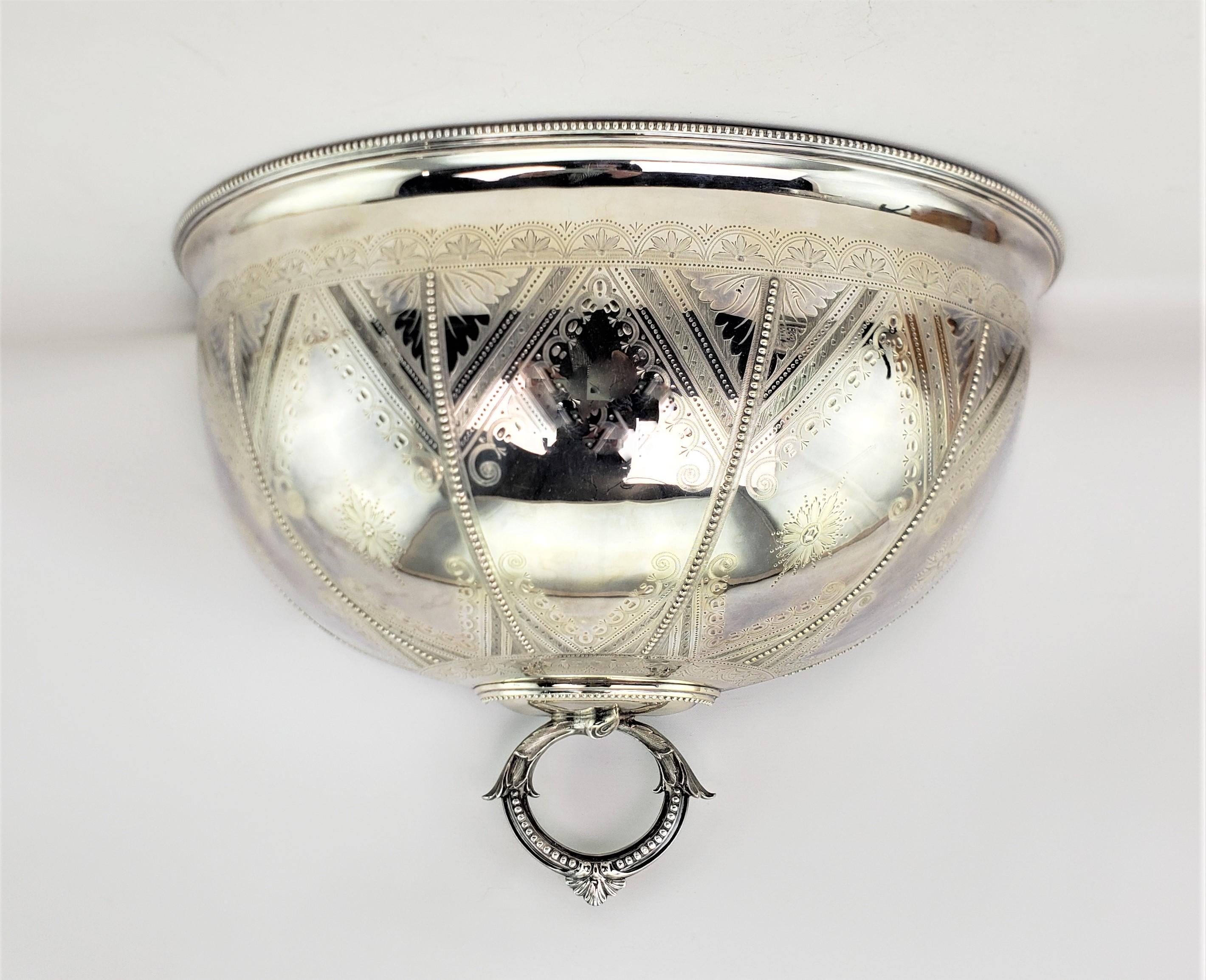 This converted antique meat dome is unsigned, but presumed to have originated from England and date to approximately 1880 and done in the period Victorian style. The half meat dome is composed of silver plate and is ornately engraved with a diamond