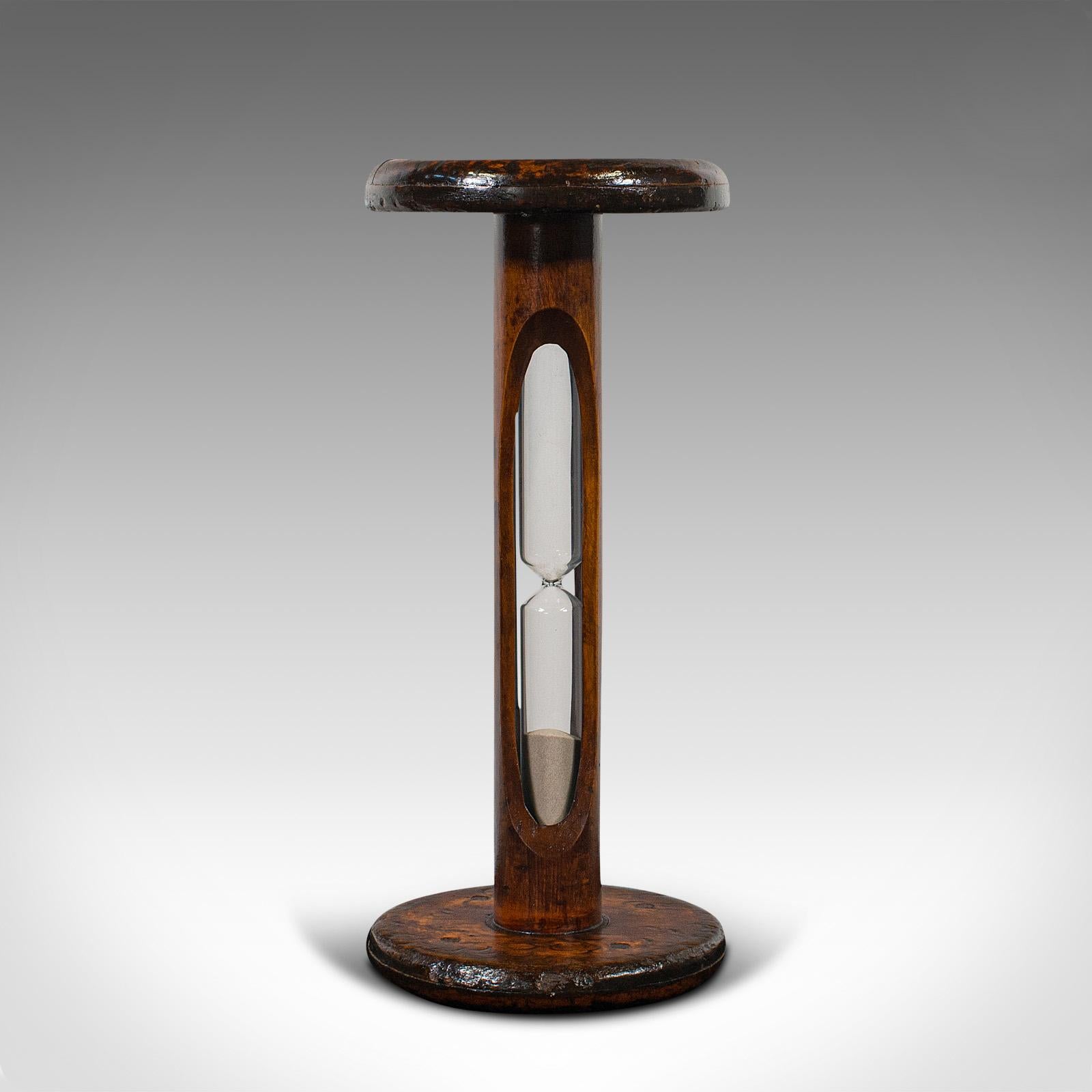 This is an antique cookie baking timer. An English, fruitwood spool and glass 10 minute sand timer, dating to the Victorian period and later, circa 1900.

Charming timer set within an antique spool
Displays a desirable aged patina