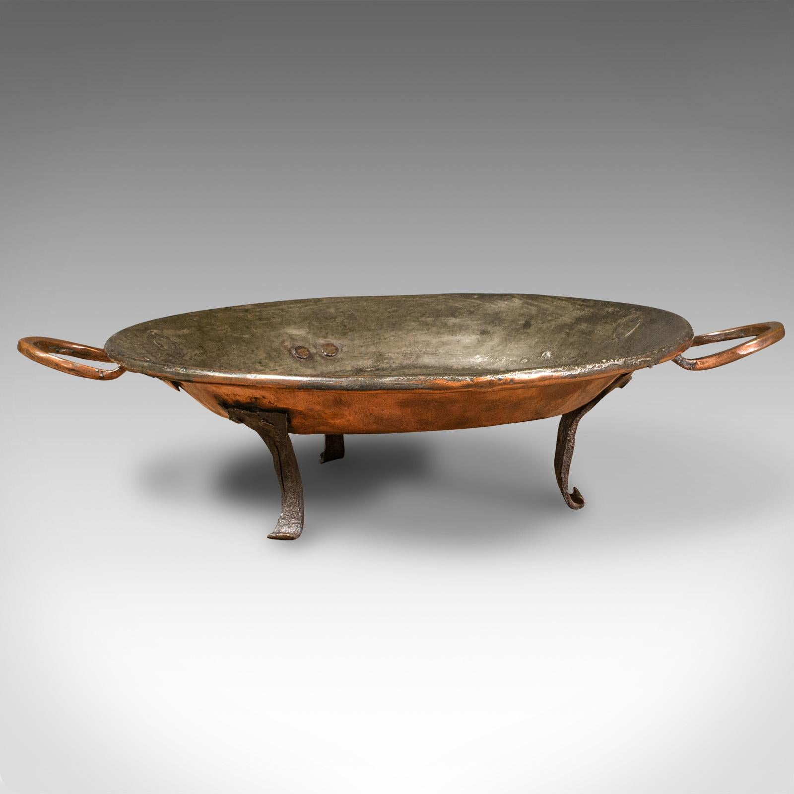 This is an antique cooking dish. An English, copper decorative tray, dating to the Georgian period, circa 1750.

Wonderfully hand-beaten and forged antique dish
Displays a desirable aged patina throughout
Copper and tinned copper hues contrast