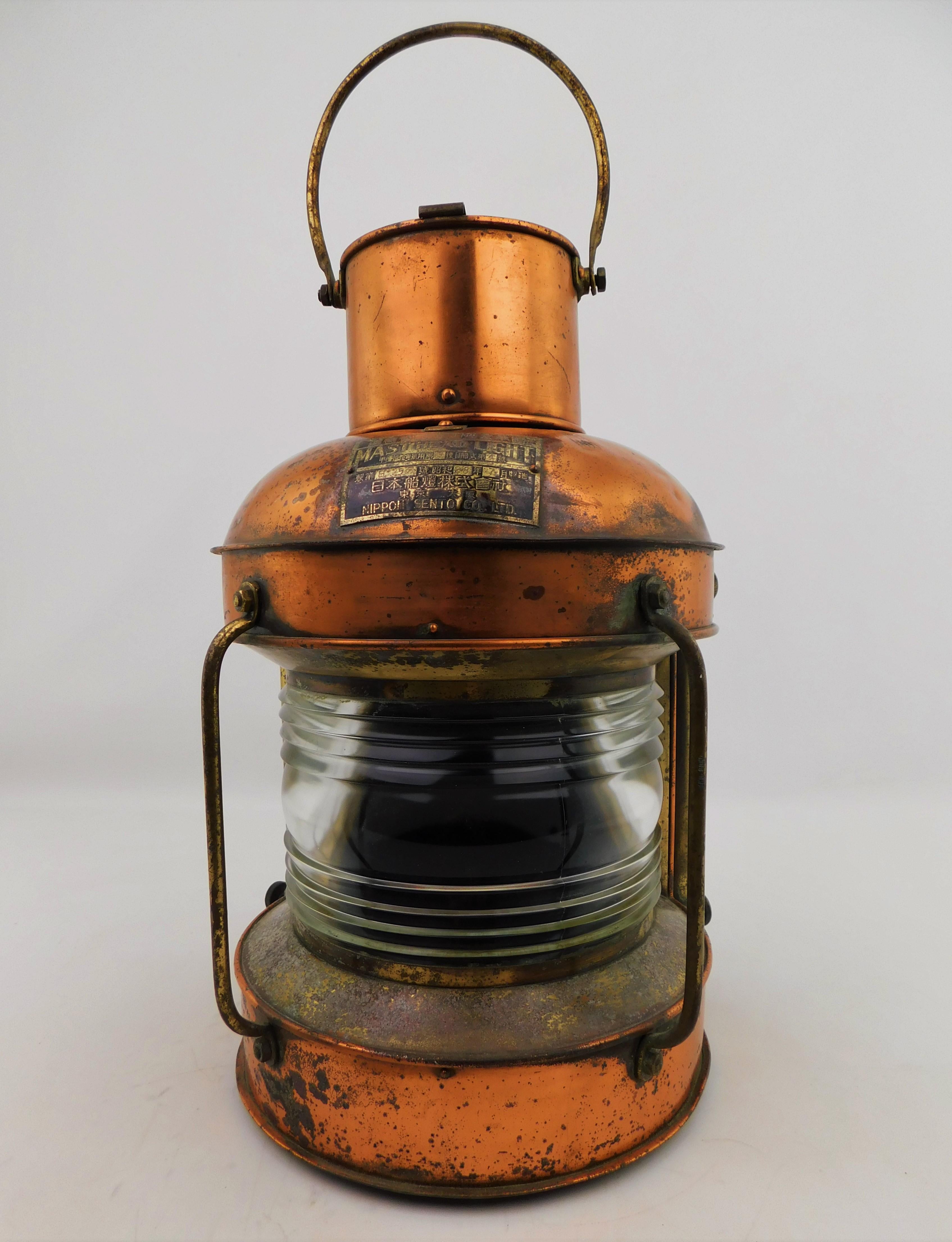 This is a large vintage solid copper and brass nautical 203 Mast head Light, Maritime signal lantern/lamp with Fresnel lens, from the famous Japanese Company “Nippon Sento Co. Ltd” which was founded in 1936. With carrying hoisting handle and two big
