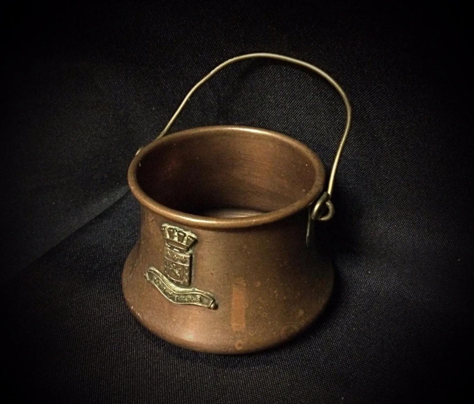 This antique copper cauldron, engraved with 
