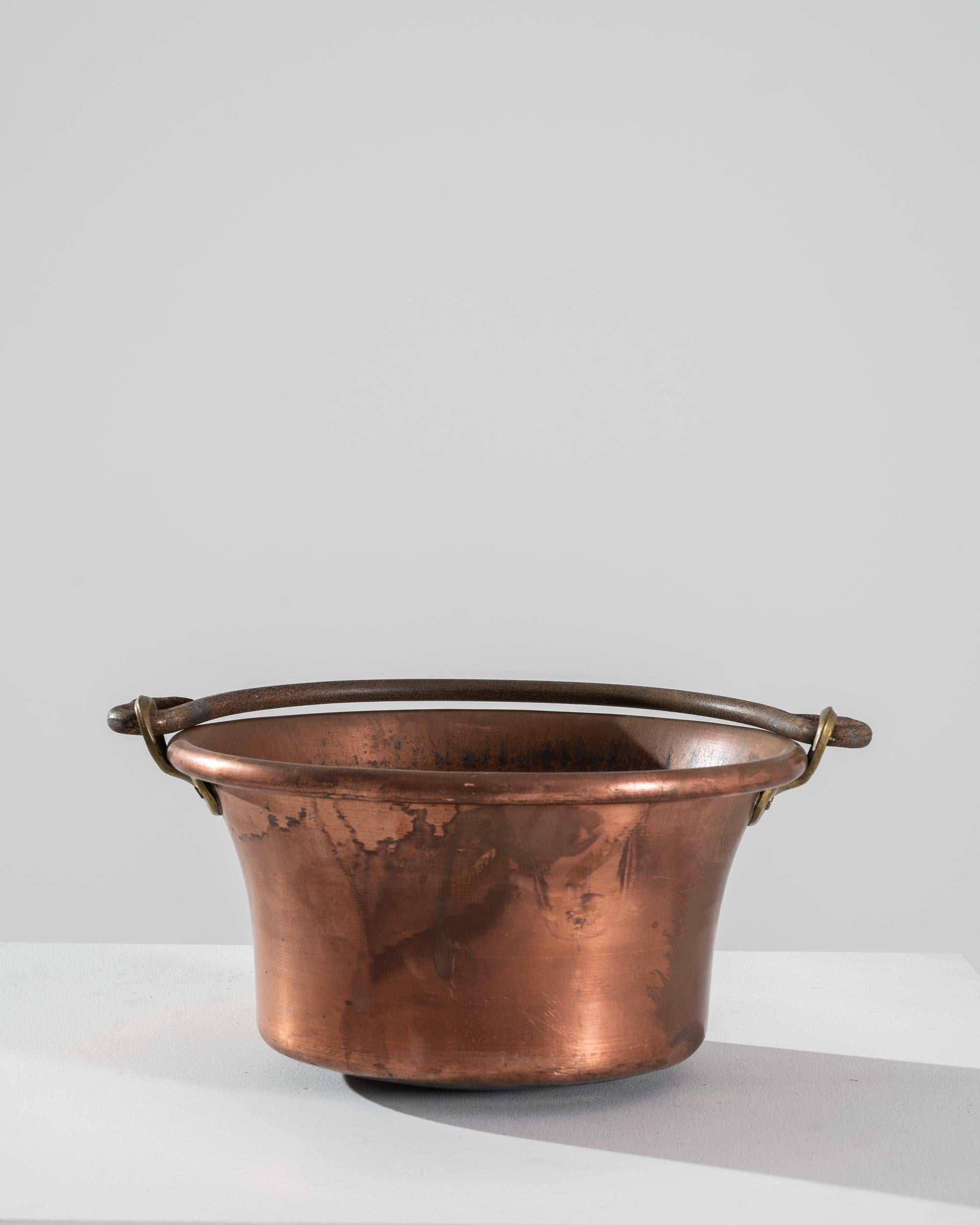 A copper pot from Belgium, circa 1900. Totally handmade, this pot features a beautiful oxidized patina layering the original polished finish. These artisanally crafted pots were made with care and detail, along with high quality materials produced