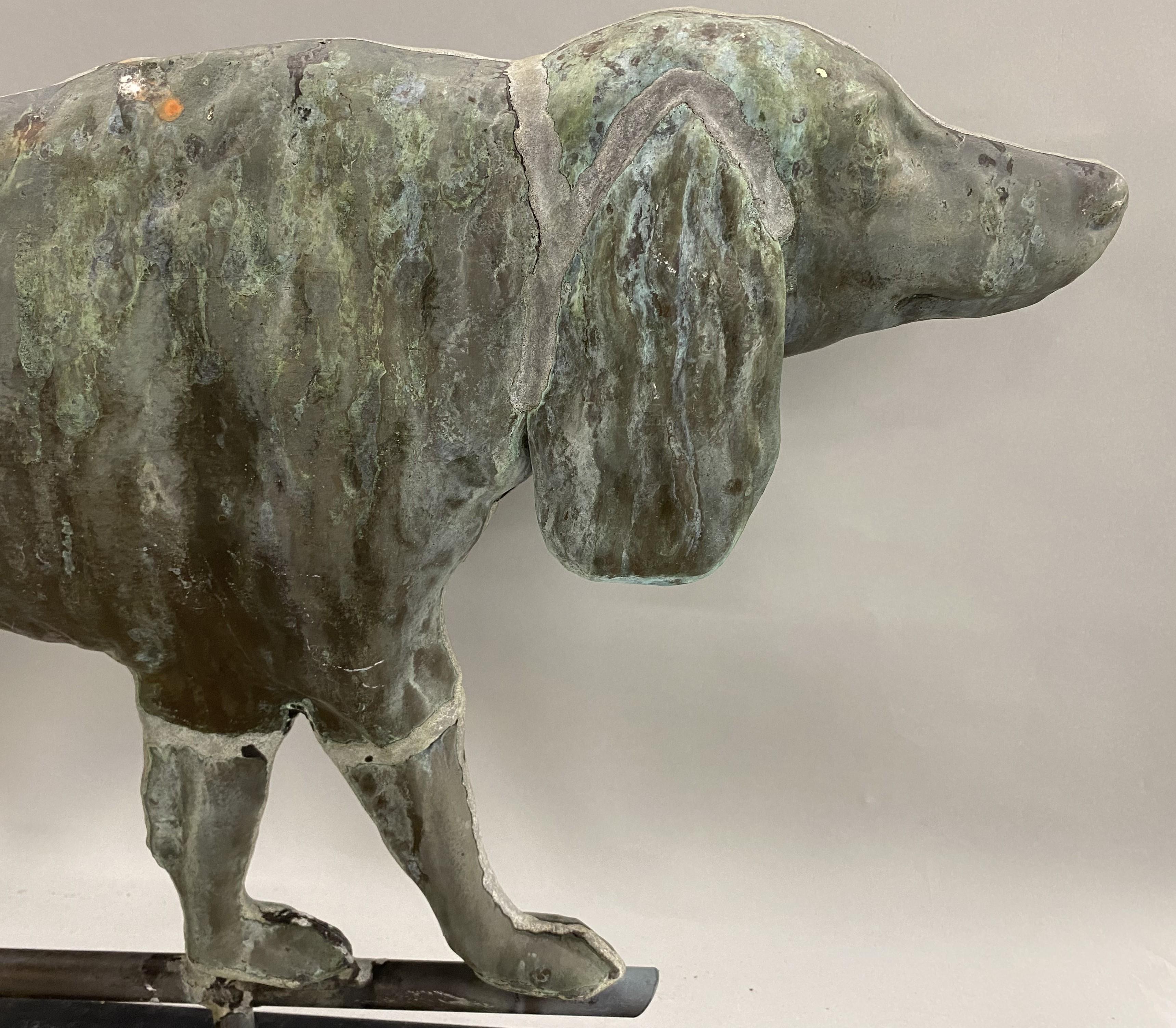 A fine hollow body English Setter dog weathervane loosely mounted on a custom black painted iron stand with great surface patina verdigris. Dates to the early 20th century in very good condition, with minimal imperfections, losses, and wear.