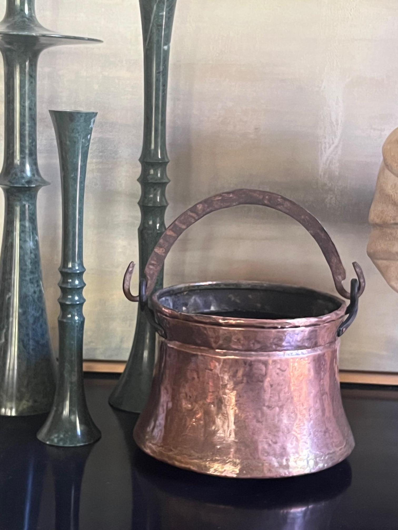 Antique copper cauldron with a top rolled edge, dovetail seams and wrought iron handle. The measurements are the cauldron only.