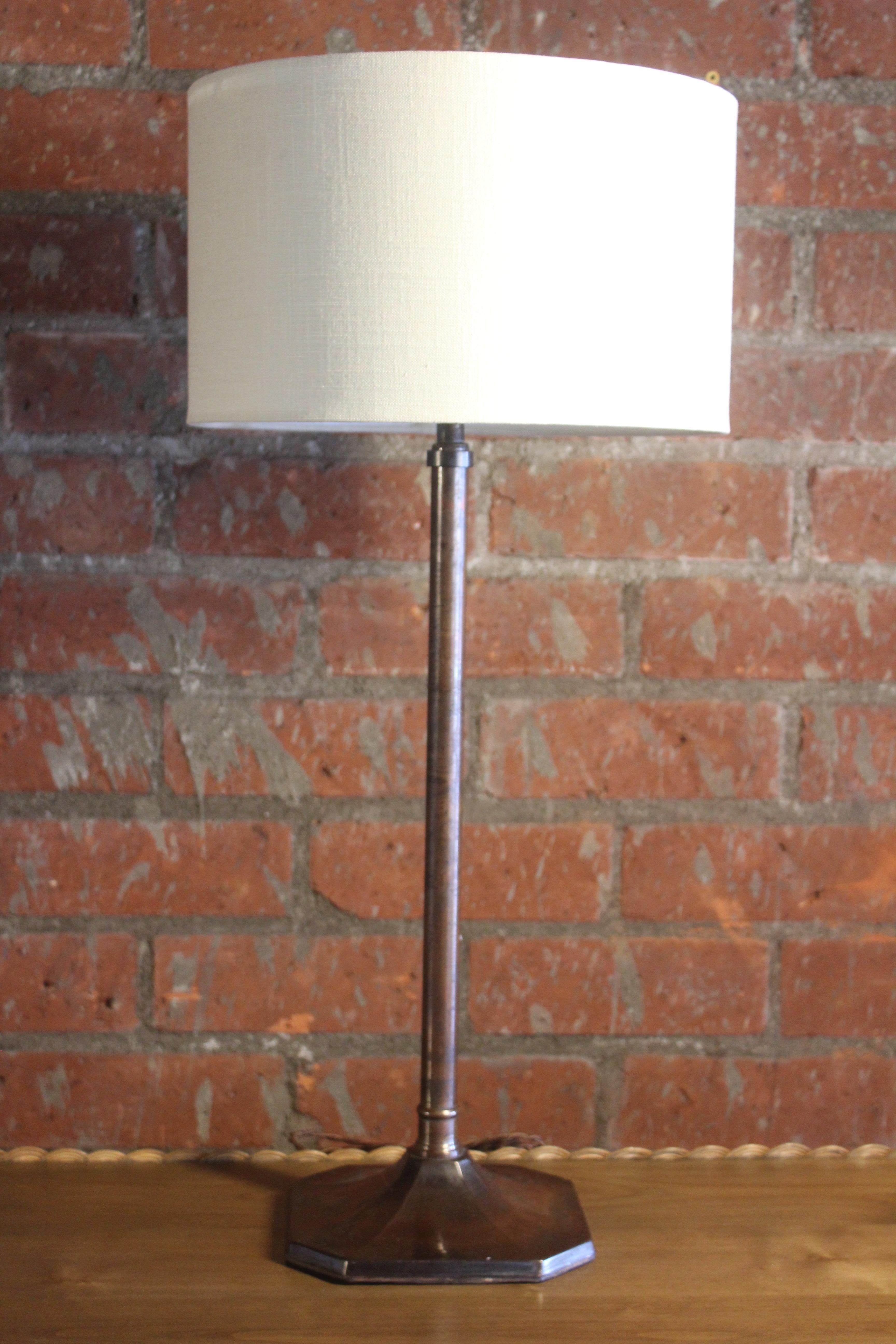 A vintage English table lamp in copper. Newly rewired and fitted with a custom shade in linen. 