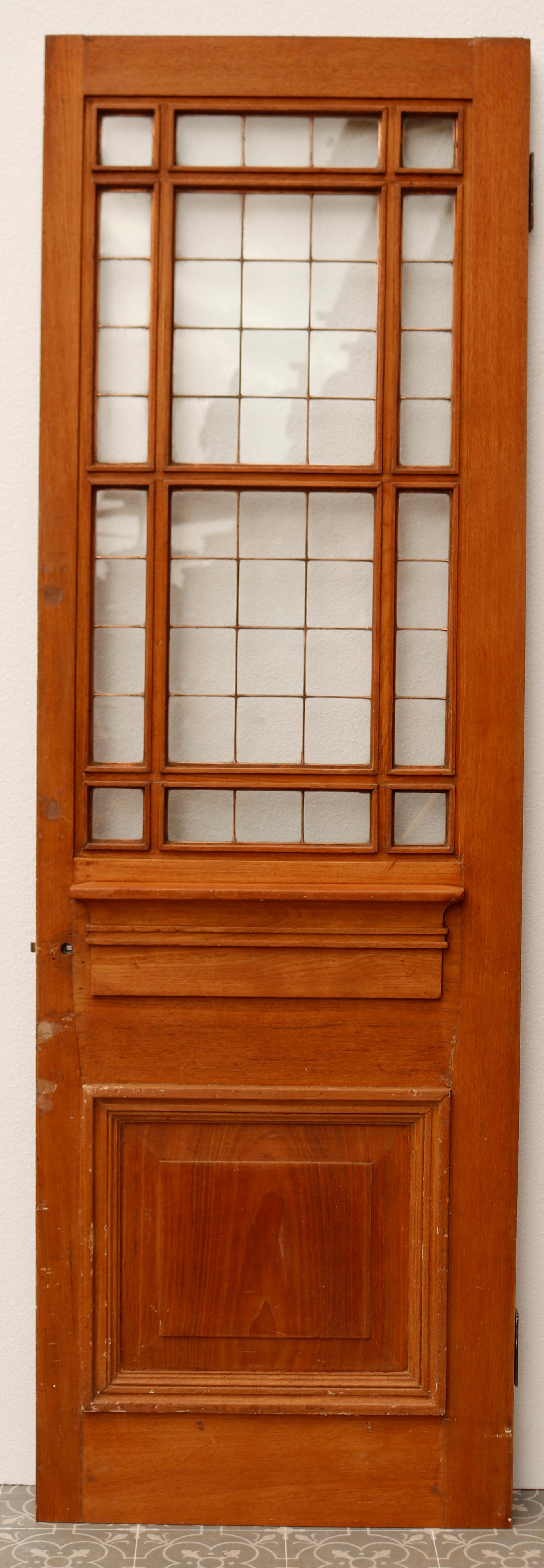 Copper light teak door. A beautiful antique door with applied mouldings, raised and fielded lower panel in an Art Deco fashion.