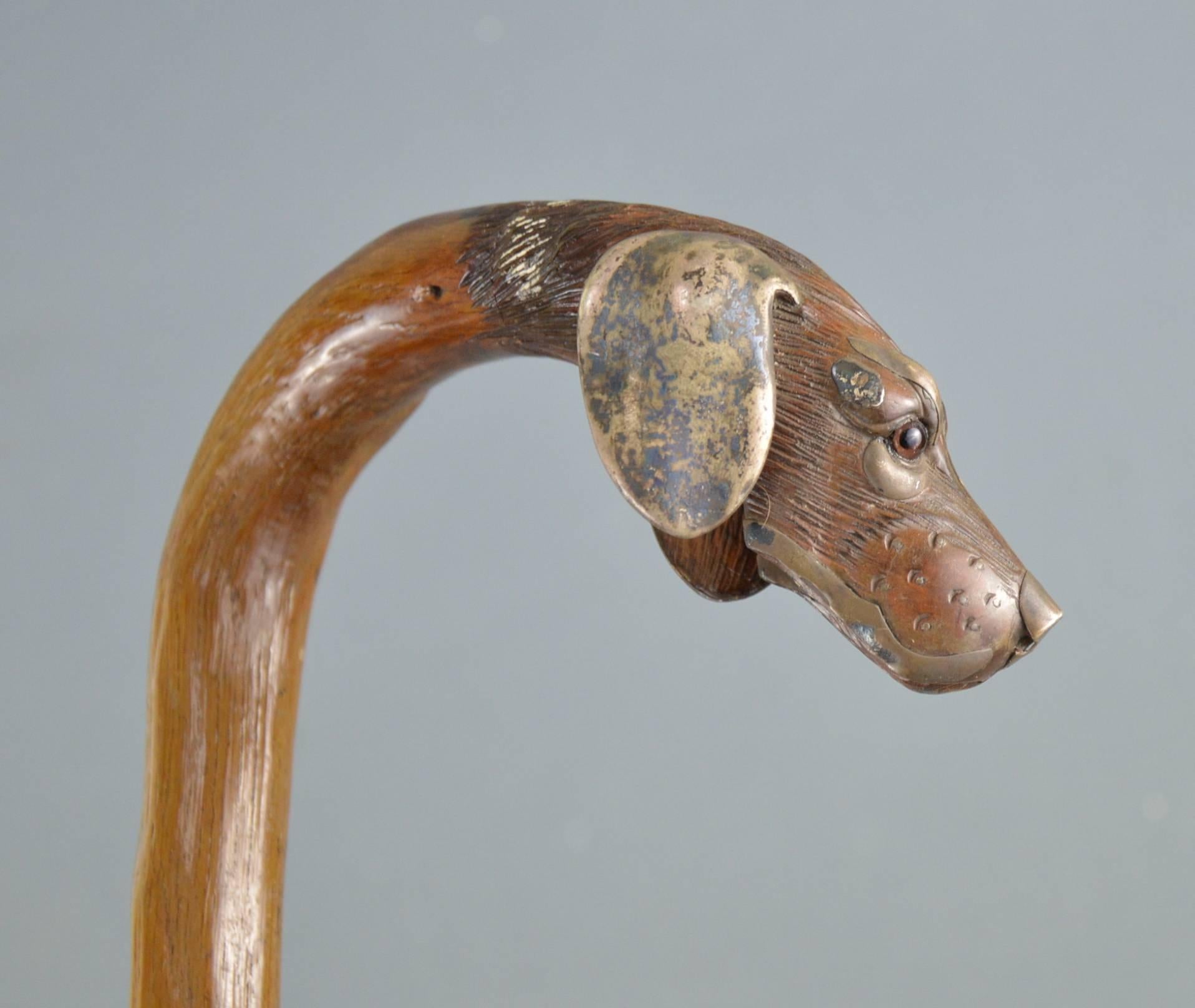 Antique copper-mounted carved wooden dogs head walking stick, circa 1900.
