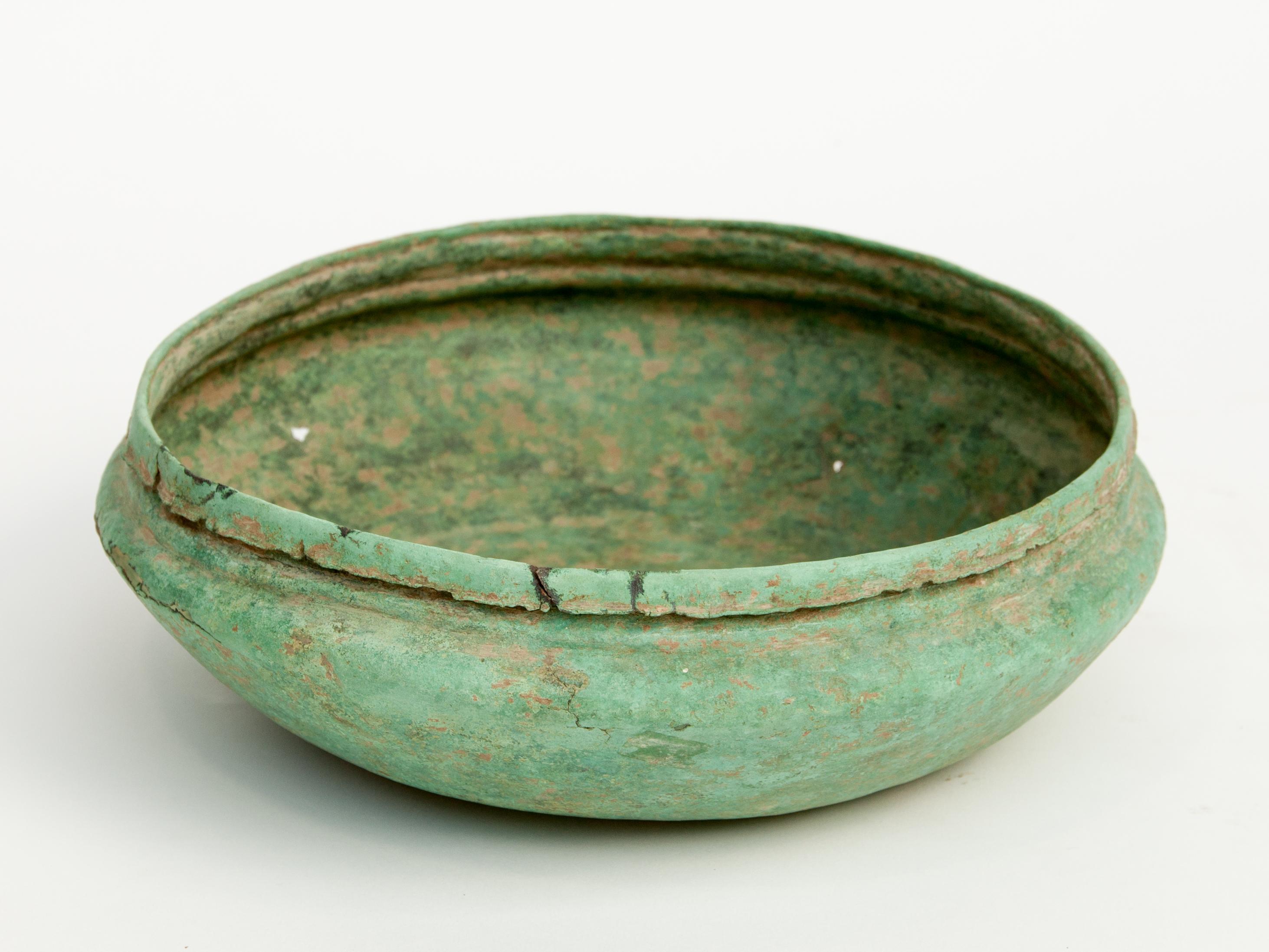 Antique copper or bronze offering bowl from Eastern Thailand (Tak Province), 19th century or earlier.
Verdigris patina. Most probably functioned as a monk's ceremonial or offering bowl.
Condition: The bowl is in distressed condition with
