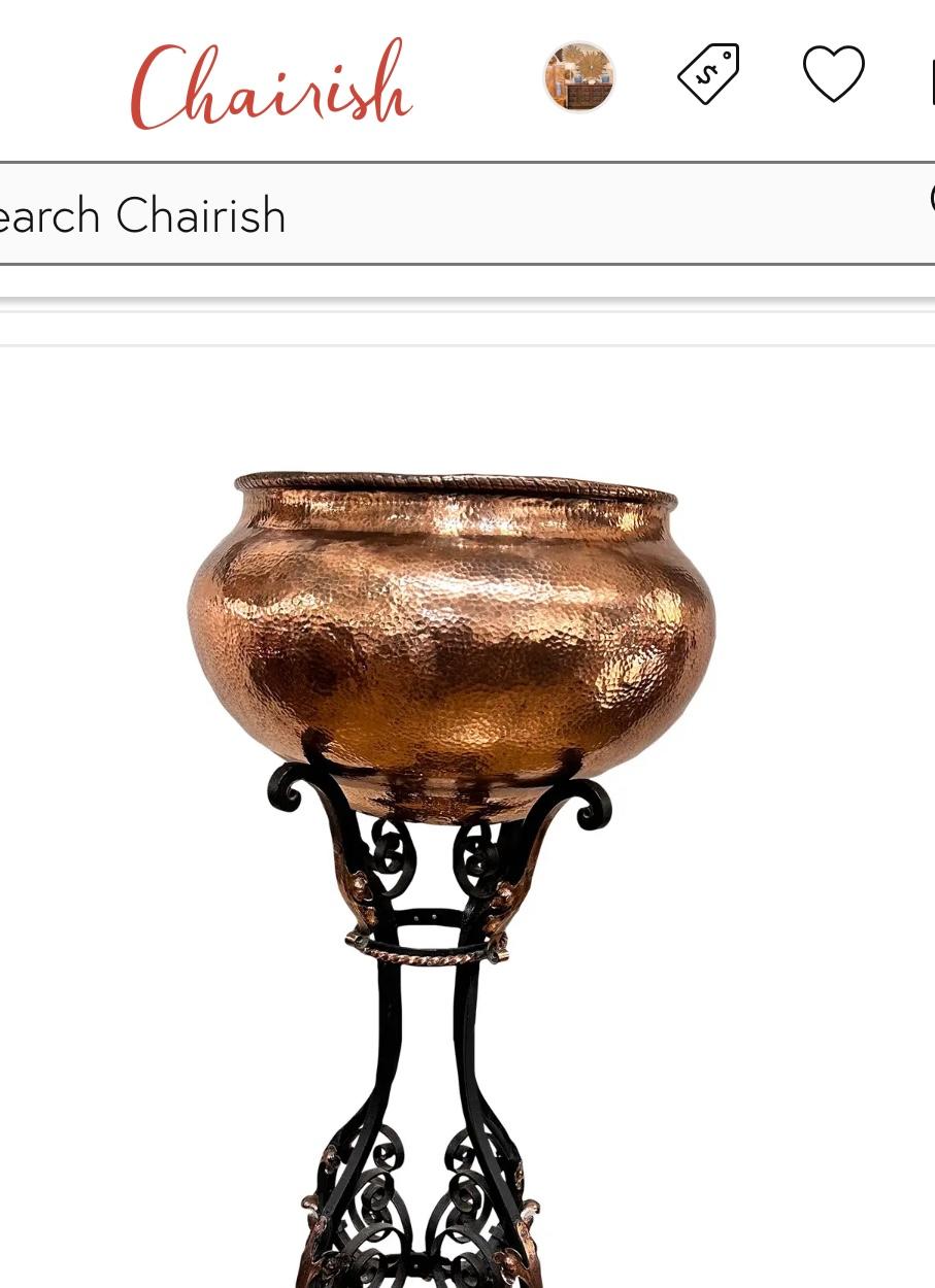 This is a gorgeous antique planter! The base is solid iron worked into a lovely design. There are beautiful floral copper accents all along the base, running up to the top to meet the copper bowl. The copper and iron are both in excellent condition