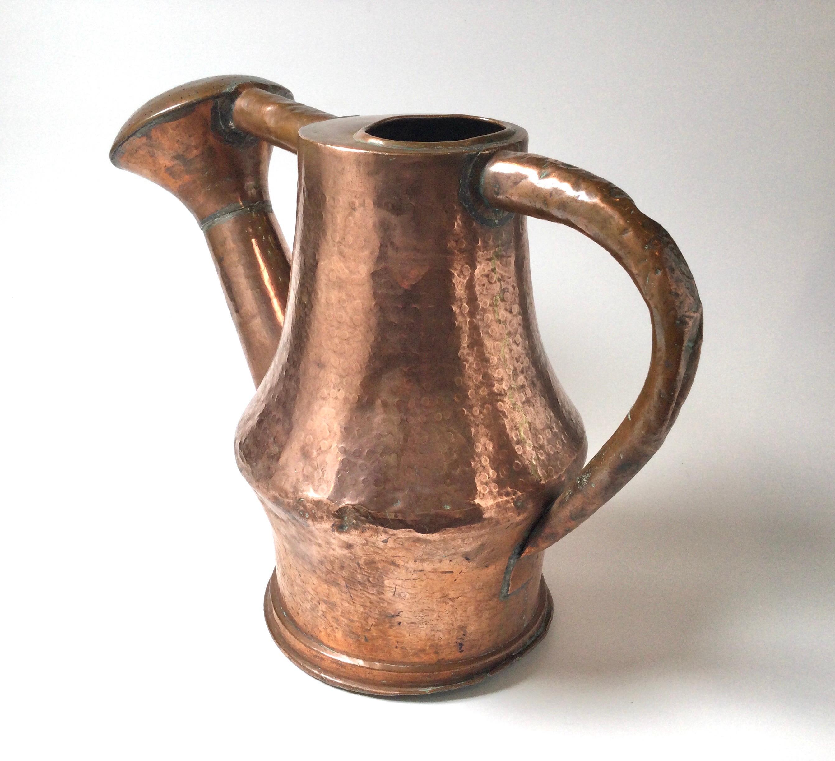 Antique large hammered copper watering can with a large rose front with wide spout. Well designed and very good condition for its age, slight dining on the very bottom edge and a few dents on the body. 




 