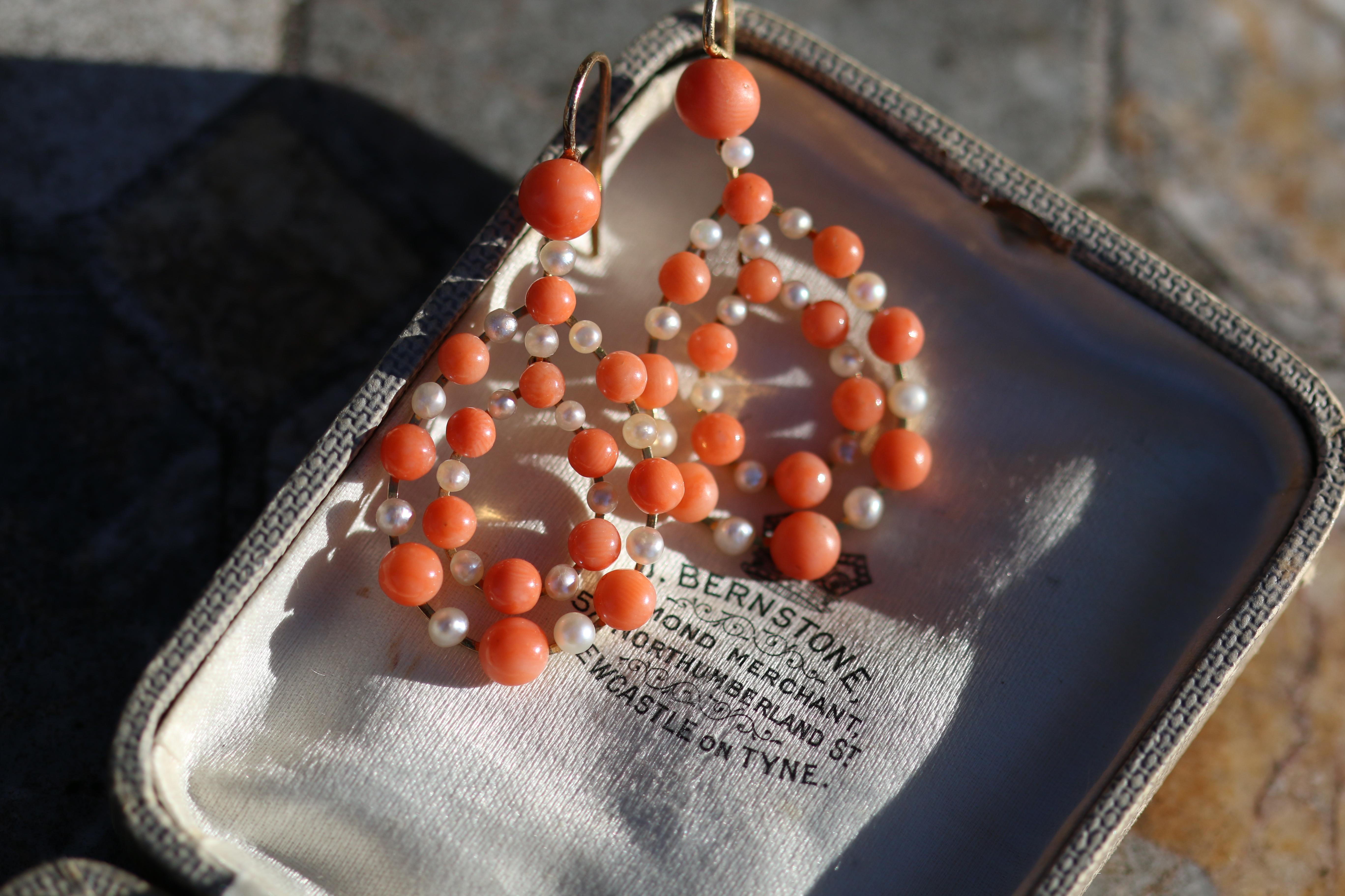 Antique Coral and Pearl Earrings create blissful concentric teardrops of timeless style.

The antique coral is a beautiful orange colour. In the shade, it has quite a deep and rich colour. However, when the sunlight hits it, it becomes a beautiful