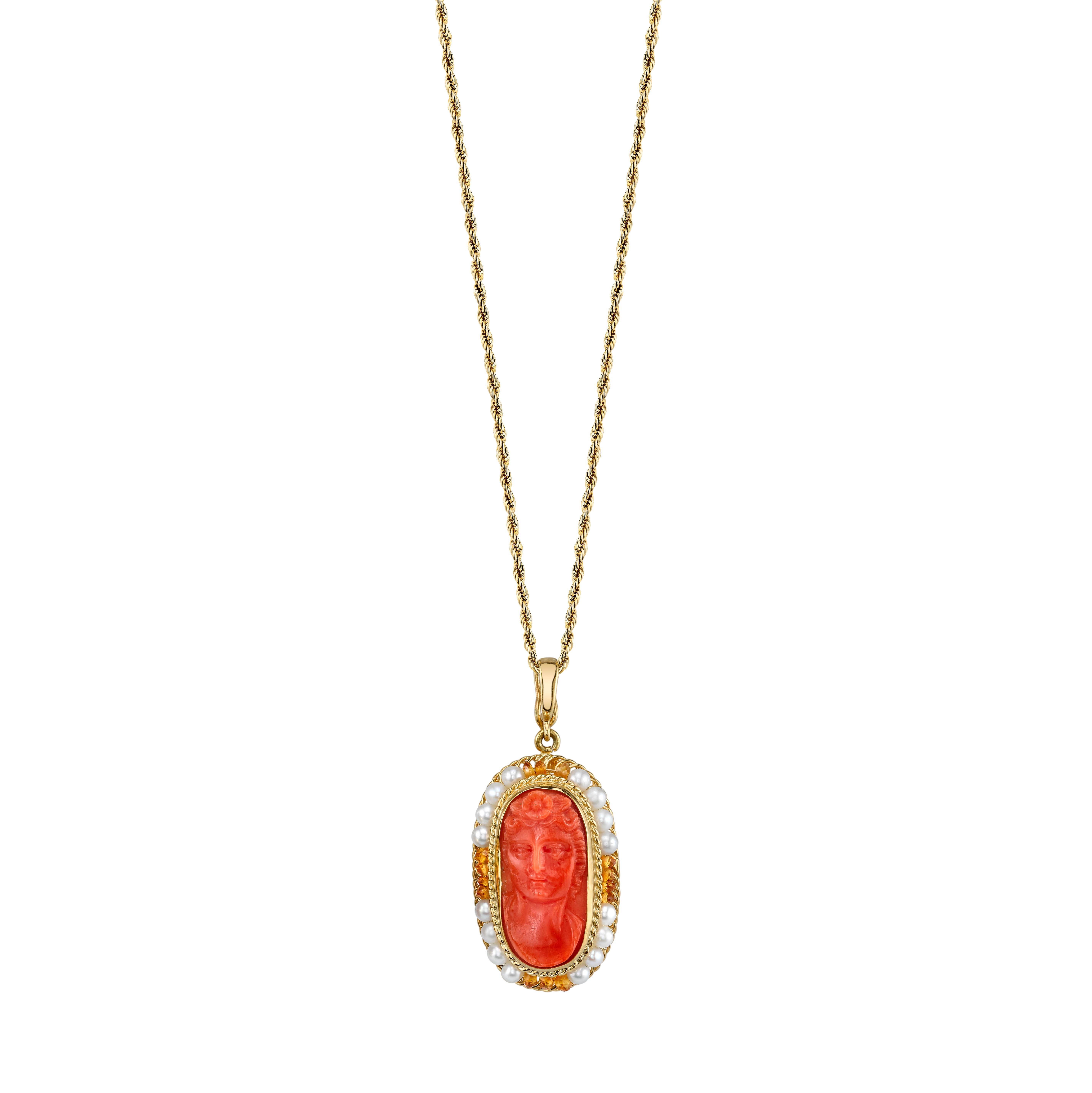 A natural color, antique coral cameo is encircled with seed pearls and citrine beads in this pretty and intricately designed drop pendant enhancer. This form of 100% handmade filigree craftsmanship uses 18k gold wire in a nearly lost art form rarely