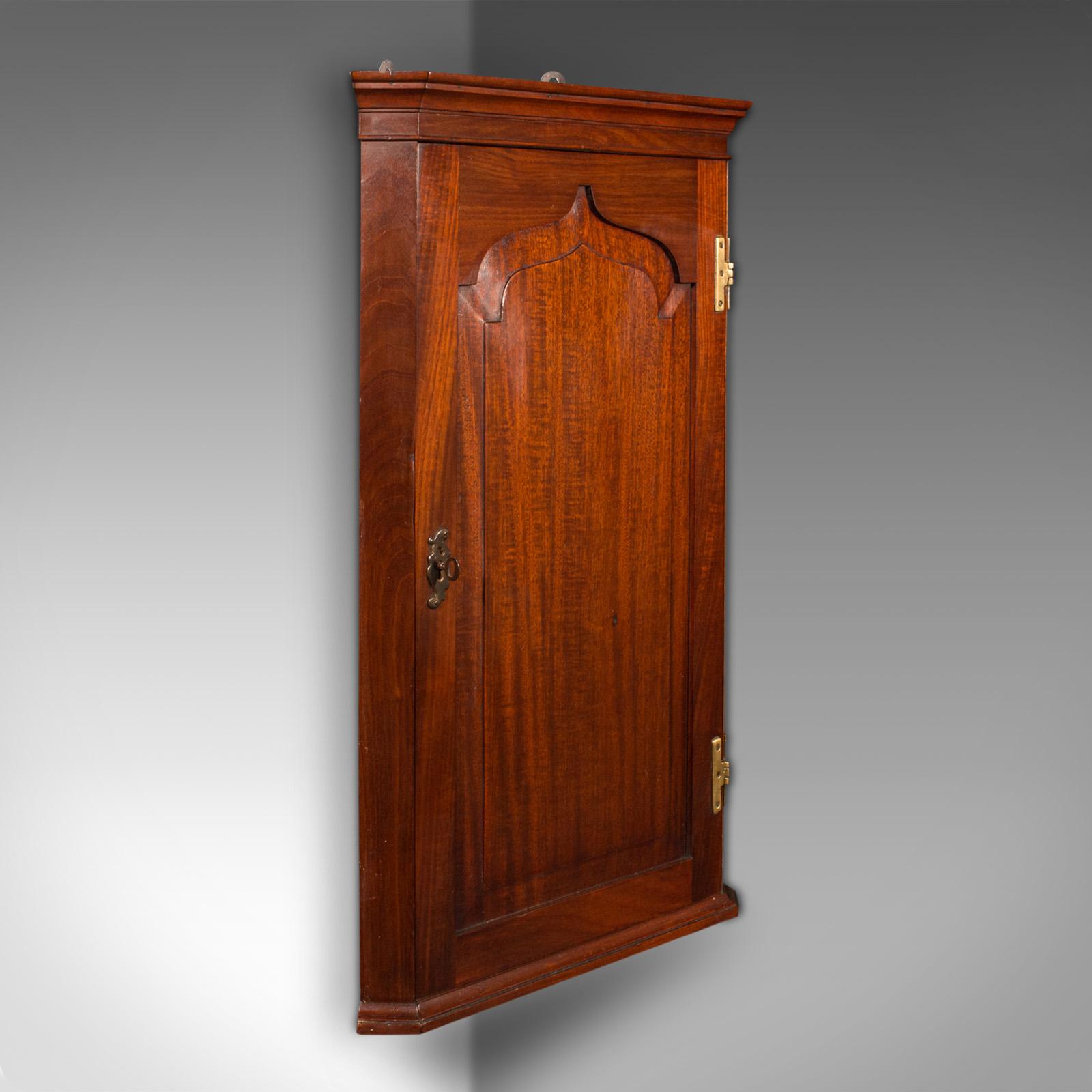 This is an antique corner cabinet. An English, mahogany cupboard with Georgian revival taste, dating to the late Victoria period, circa 1880.

Delightfully figured cabinet with a bright painted interior
Displaying a desirable aged patina and in