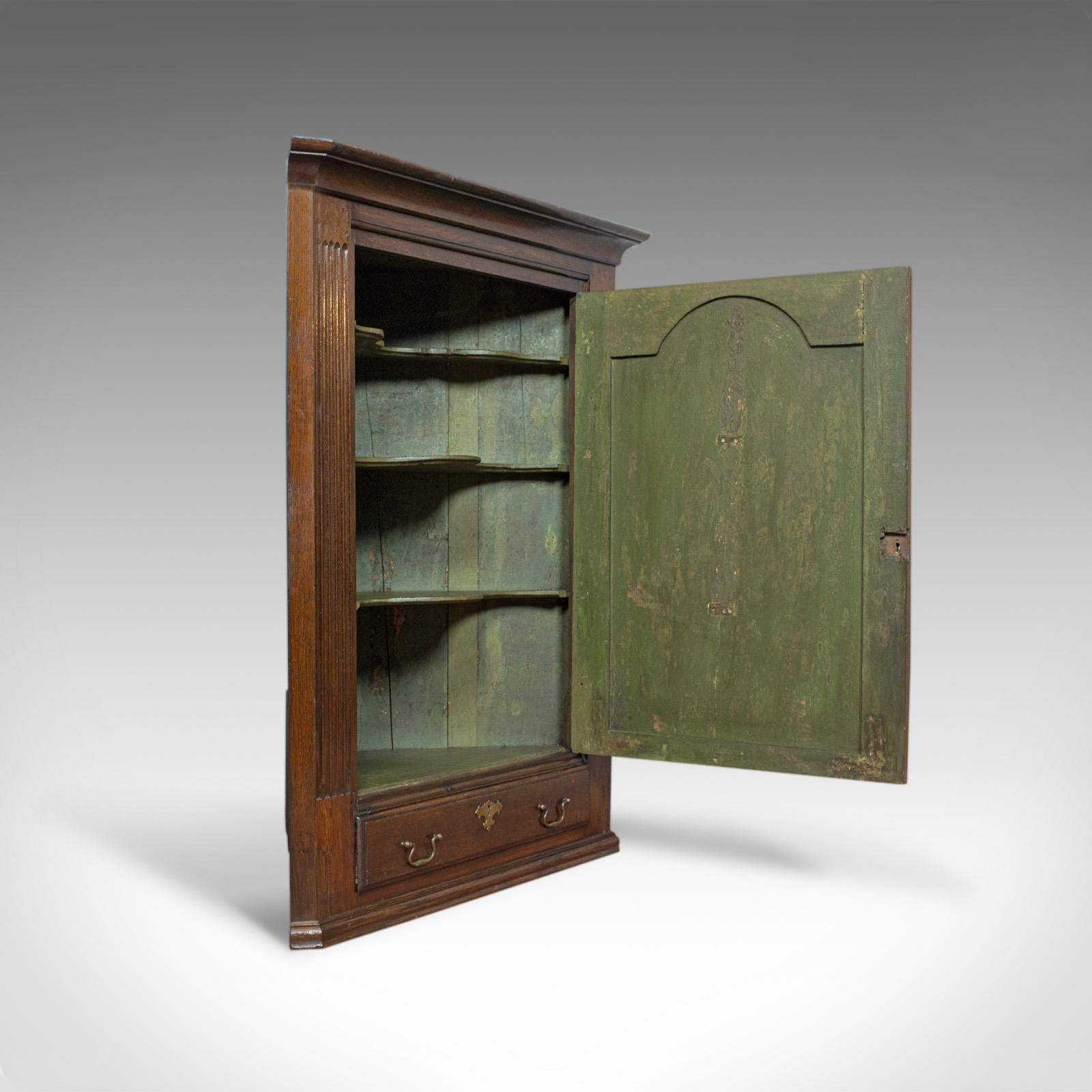 This is an antique corner cabinet. An English, Georgian, oak, hanging wall cupboard dating to the late 18th century, circa 1780.

Select oak with rich hues and in desirable aged patina
Good consistent color throughout and fine grain