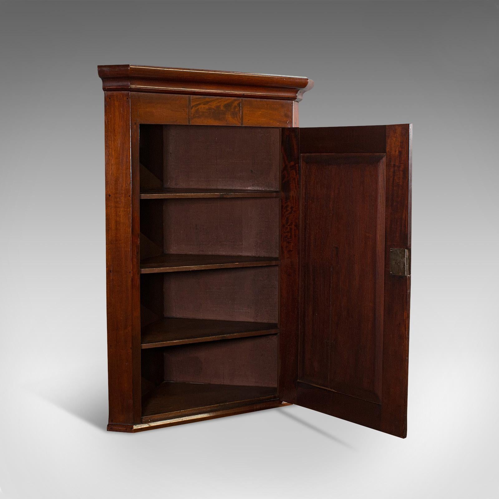 This is an antique corner cabinet. An English, mahogany and walnut cabinet with quality inlay and detail, dating to the Georgian period, circa 1800.

The superior finish exudes collectible appeal
Displaying a desirable aged patina
Select