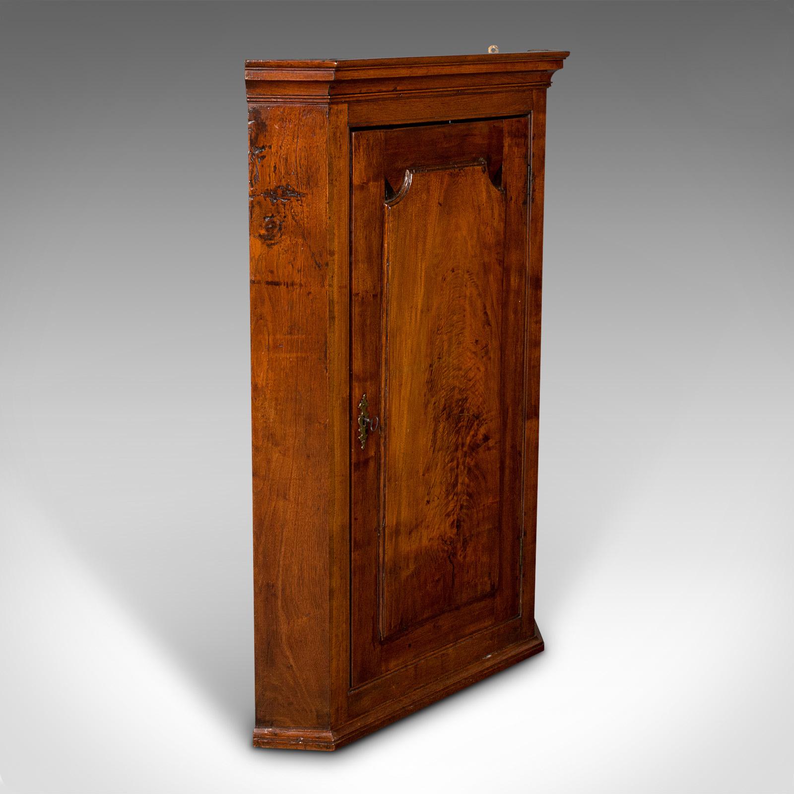 This is an antique corner cabinet. An English, mahogany and fruitwood wall cupboard, dating to the Georgian period, circa 1780.

Appealing Georgian corner cupboard with fine figuring and color
Displays a desirable aged patina and in good order