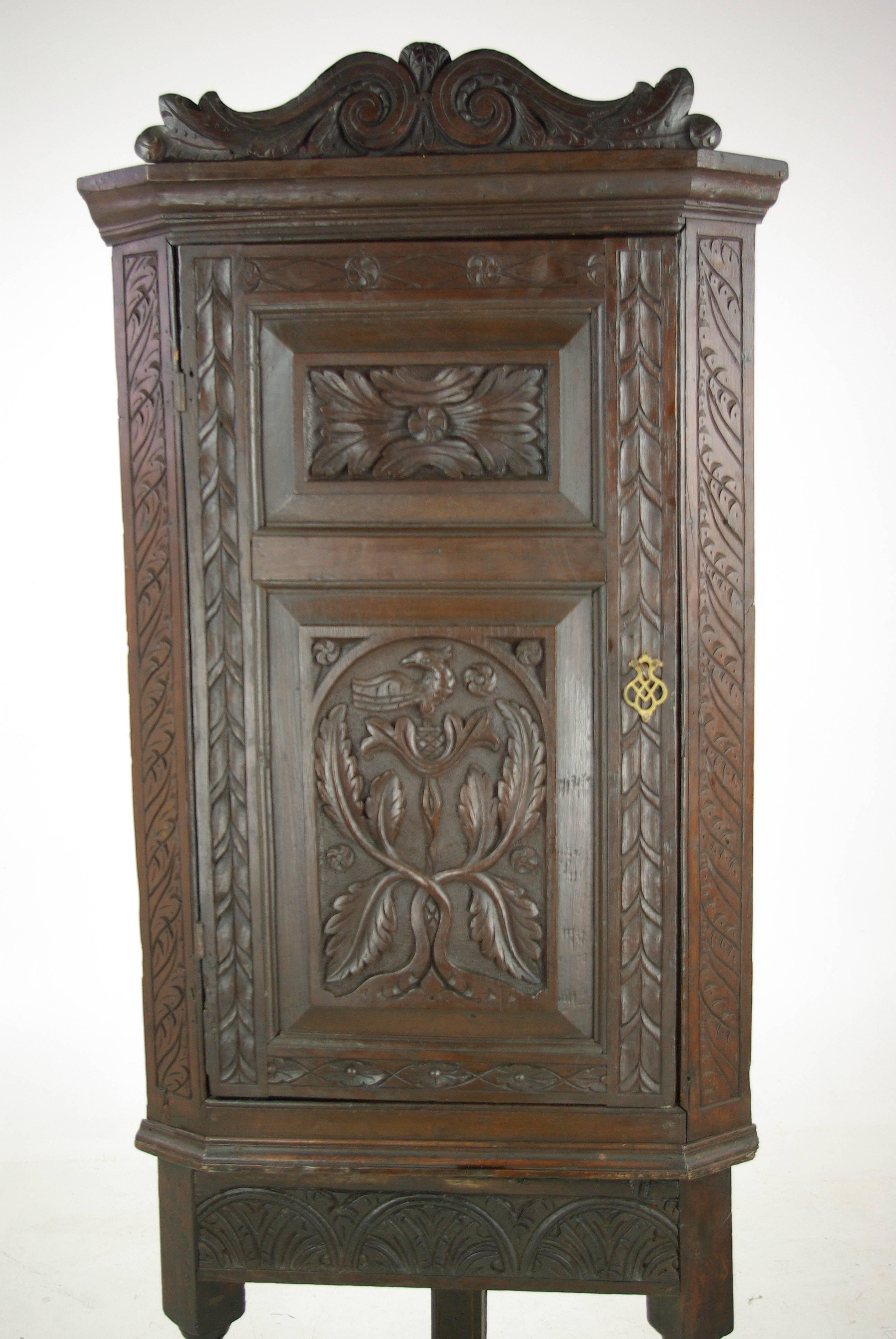 Antique Corner Cabinet, Entryway Organizer, Scotland 1780, Antique Furniture, B974 

Scotland 1780-1800
Solid oak with original finish
Flared cornice with carved pediment
One carved paneled door
Carved sides
Two fixed shelves interior
Very