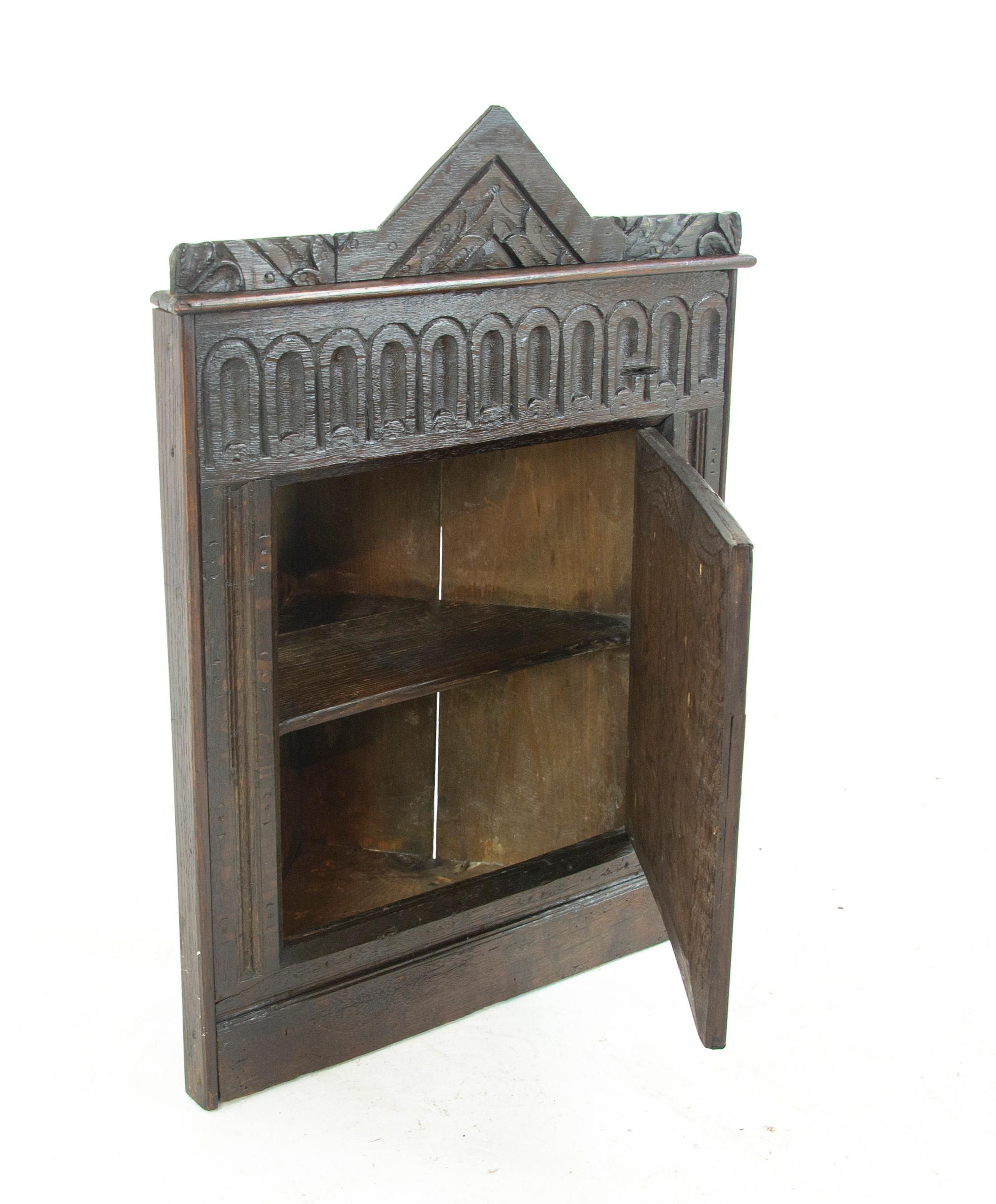 Antique corner cabinet, Victorian hanging wall cabinet, entryway furniture, Scotland 1860, Antique Furniture, B1472

Scotland 1860
Solid oak construction
Carved pediment above
Single carved door below
Fitted interior with single shelf
All original