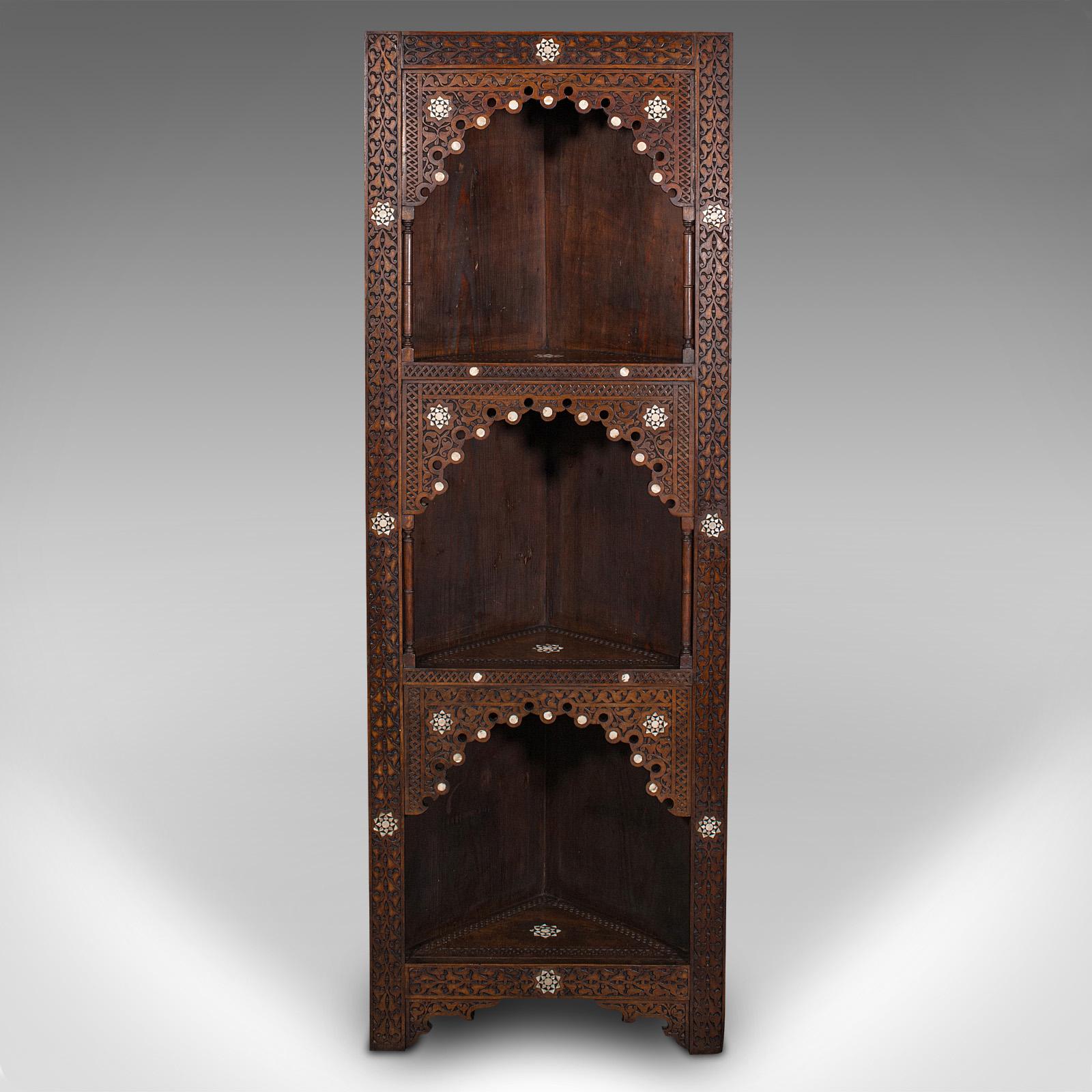 This is an antique corner display stand. A Middle Eastern, mahogany and pine open shelf cabinet in Moorish taste, dating to the late Victorian period, circa 1900.

Wonderfully ornate in the usual Moorish way, with a trio of shelves
Displays a